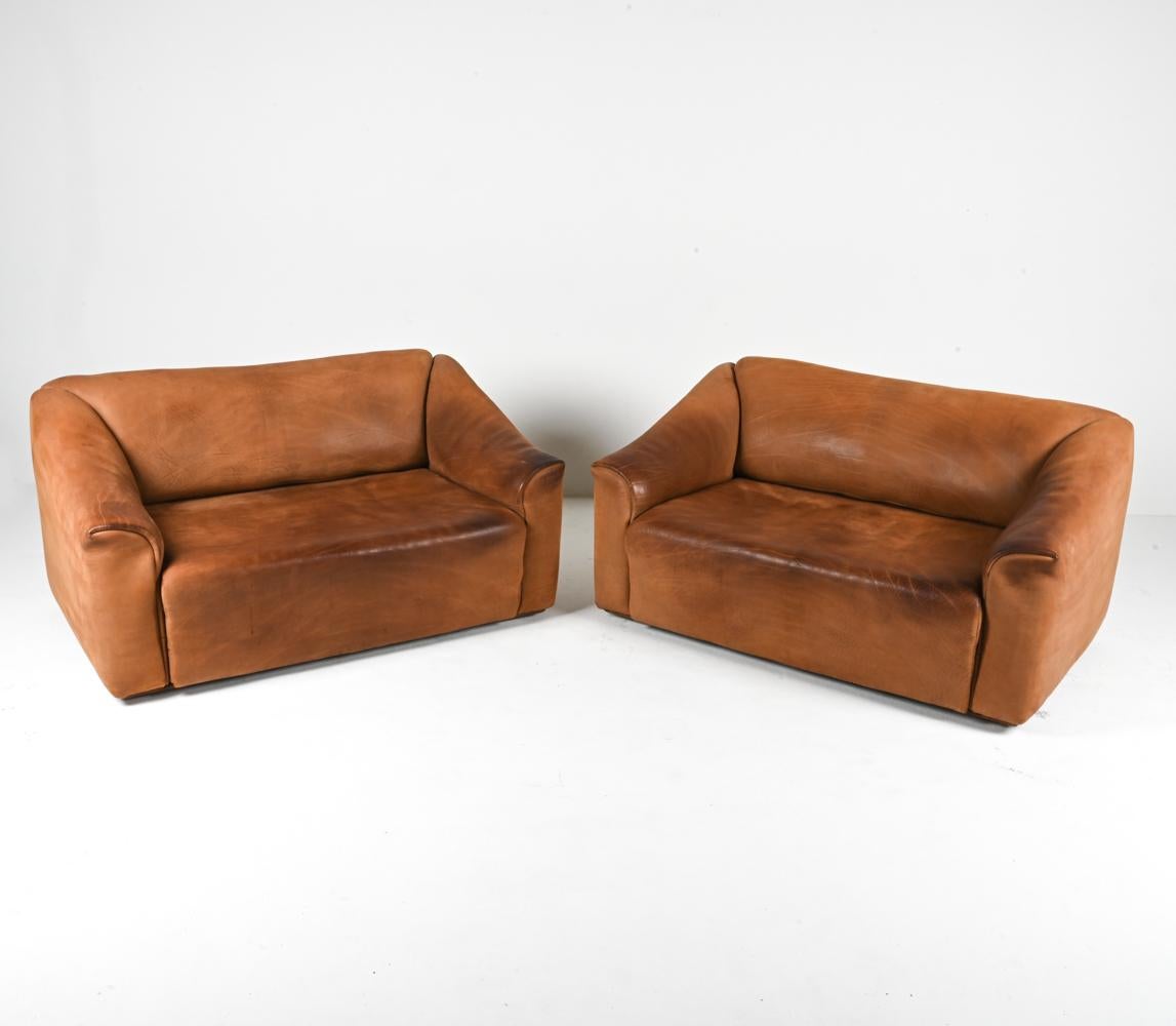 Introducing a rare and exceptional find from the iconic 1970's: a pair of De Sede DS-47 two-seat sofas in sumptuous nubuck leather. These sofas represent the pinnacle of Swiss craftsmanship and design, showcasing the artistry of De Sede and the