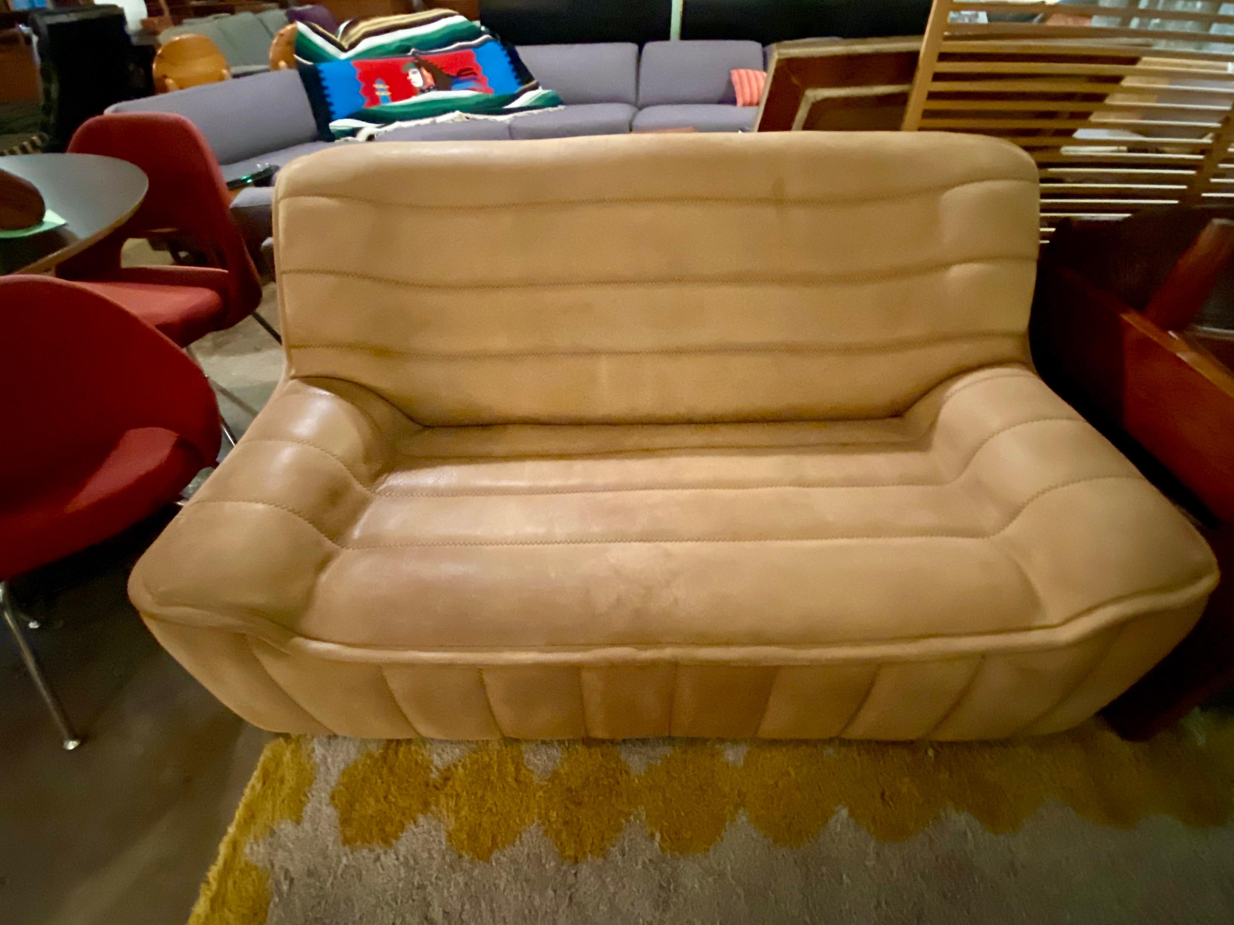 Beautiful pair of De Sede84 Sofa in Buffalo leather in warm beige color with a high back and armrests. Beautiful patina and very good condition. Made in Switzerland, de Sede is renowned for its high-quality, handcrafted luxurious leather furniture,