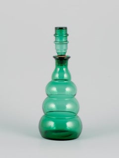 Pair of decanters in green art glass from a Swedish glassworks.
