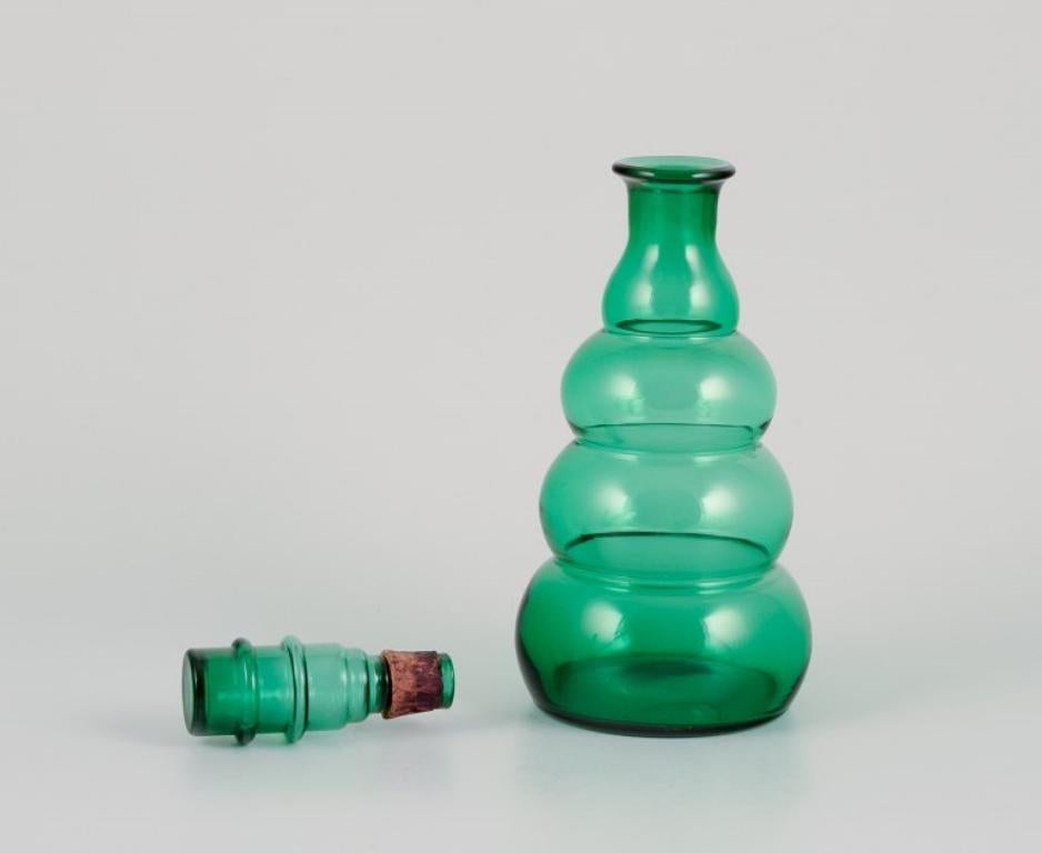 Pair of decanters in green art glass from a Swedish glassworks. In Excellent Condition For Sale In Copenhagen, DK
