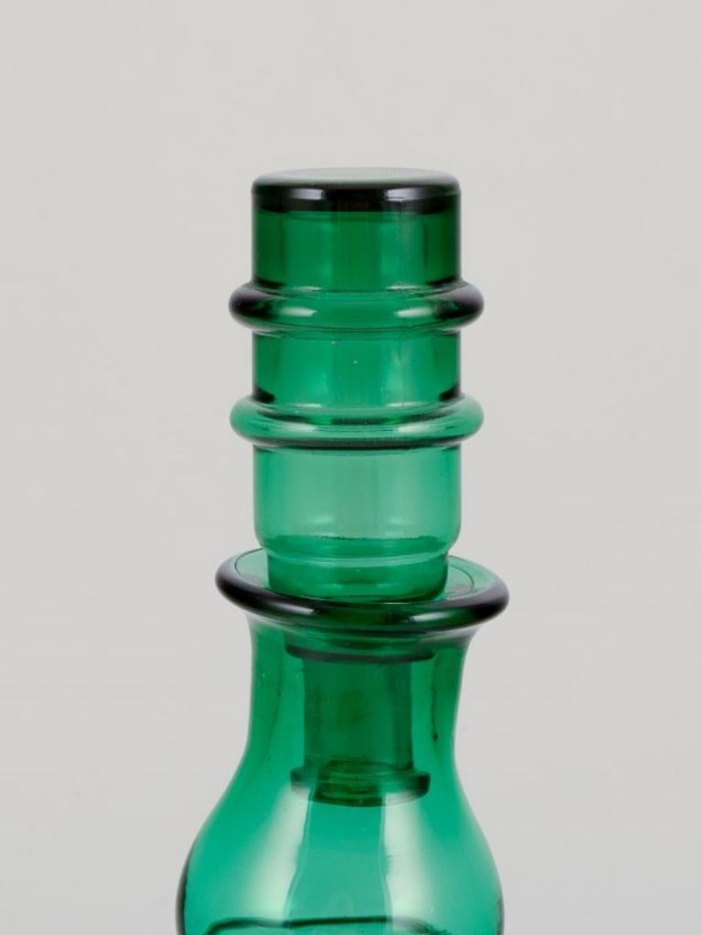 Art Glass Pair of decanters in green art glass from a Swedish glassworks. For Sale