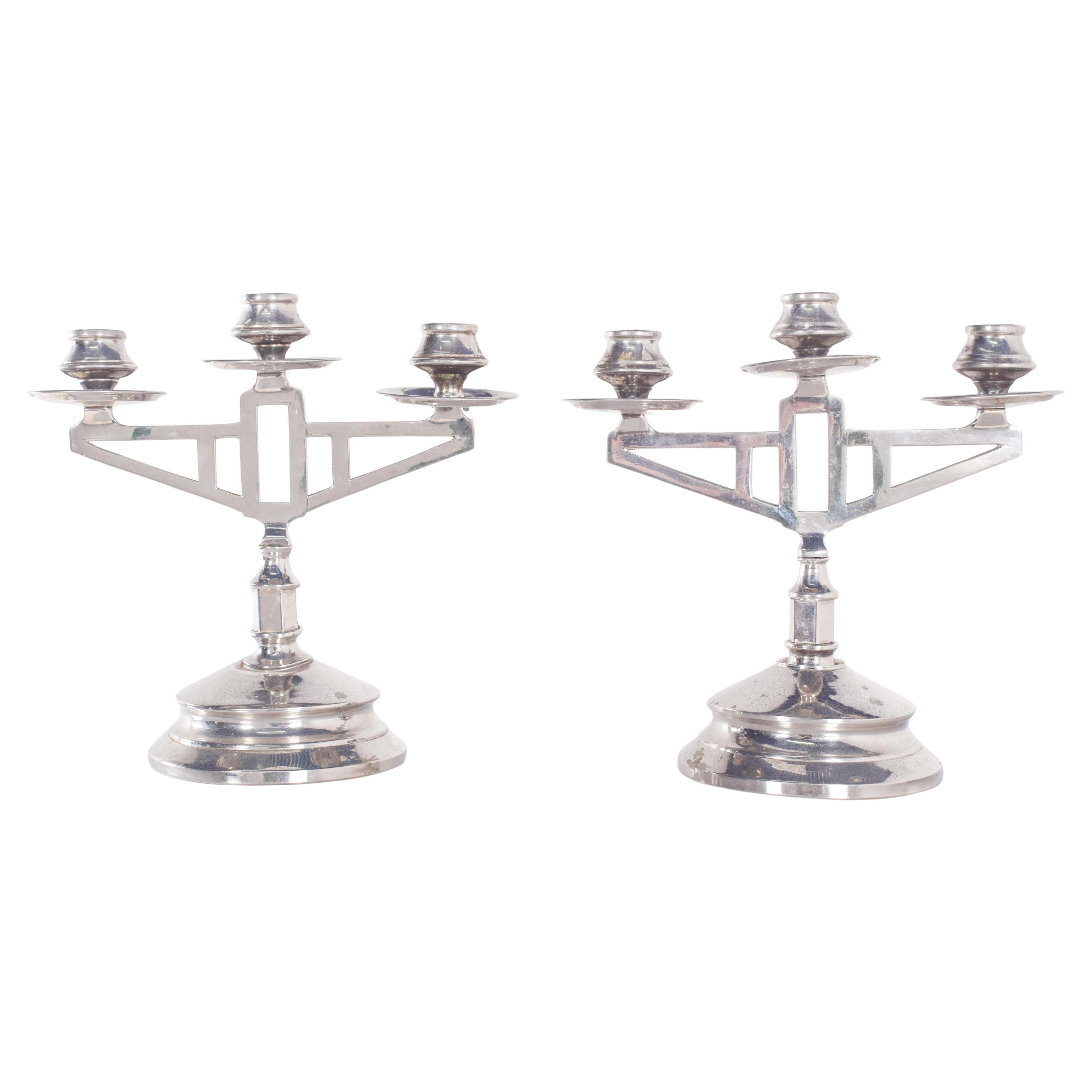 Paire de chandeliers déco en métal argenté