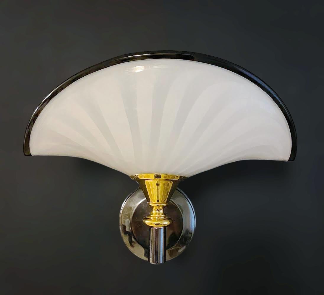 Vintage Italian wall lights with hand blown milky white fan shaped Murano glass shades mounted on gold and black nickel finish structure / Made in Italy, circa 1960s
Measures: height 9.5 inches, width 12.5 inches, depth 8 inches
1 light / E26 or E27