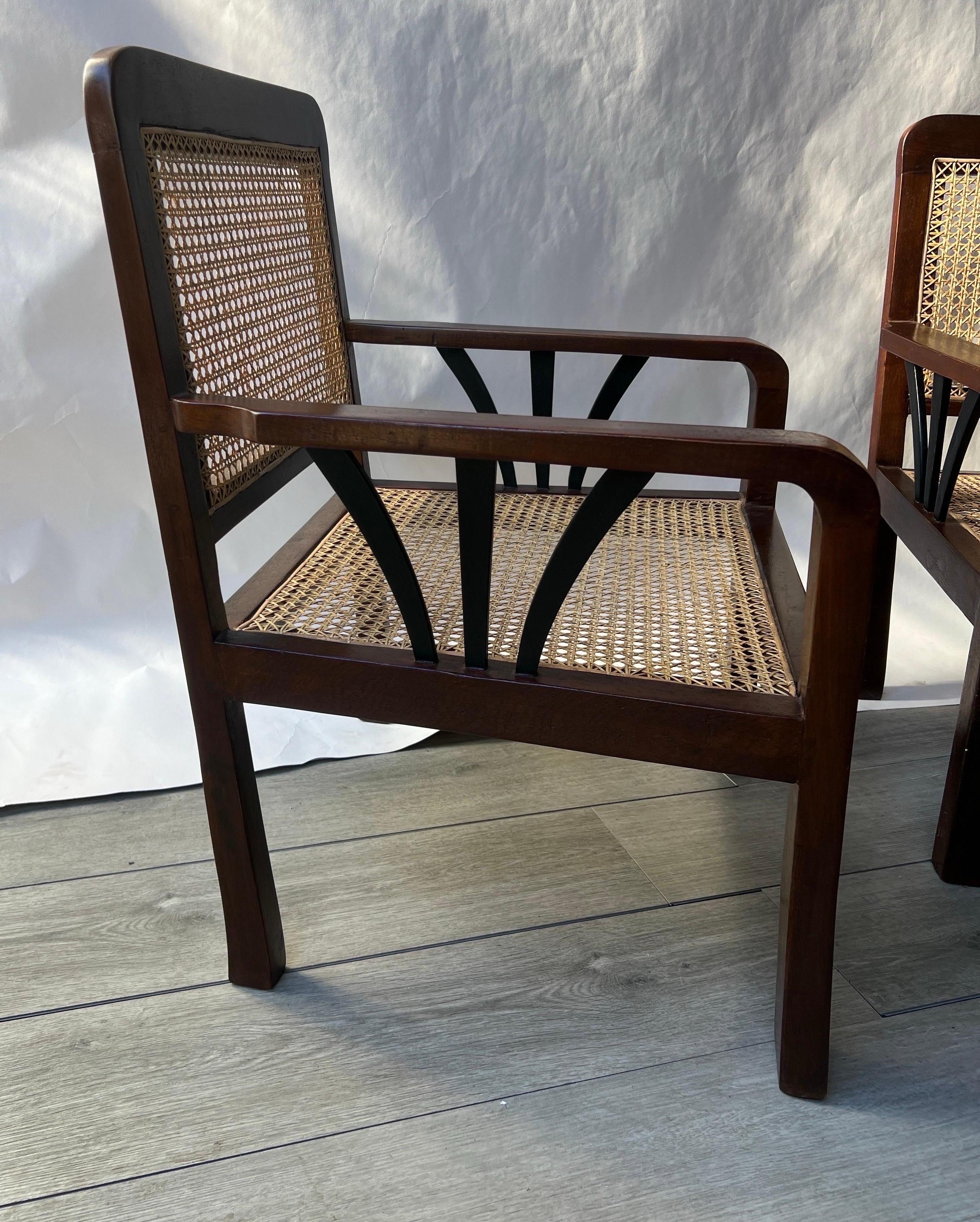 Great pair of Deco period British colonial hand caned teak wood club chairs. Recently restored and recaned. Ready for cushions or can be used as is. Matching settee also available. 