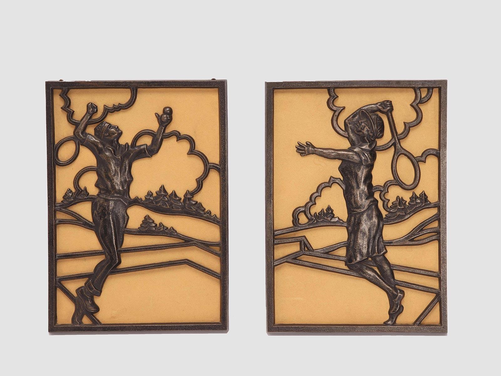 Pair of bronze plates, rectangular shape, openwork, depicting two tennis players, a man and a woman, with pine trees and clouds in the background. Austria circa 1930.