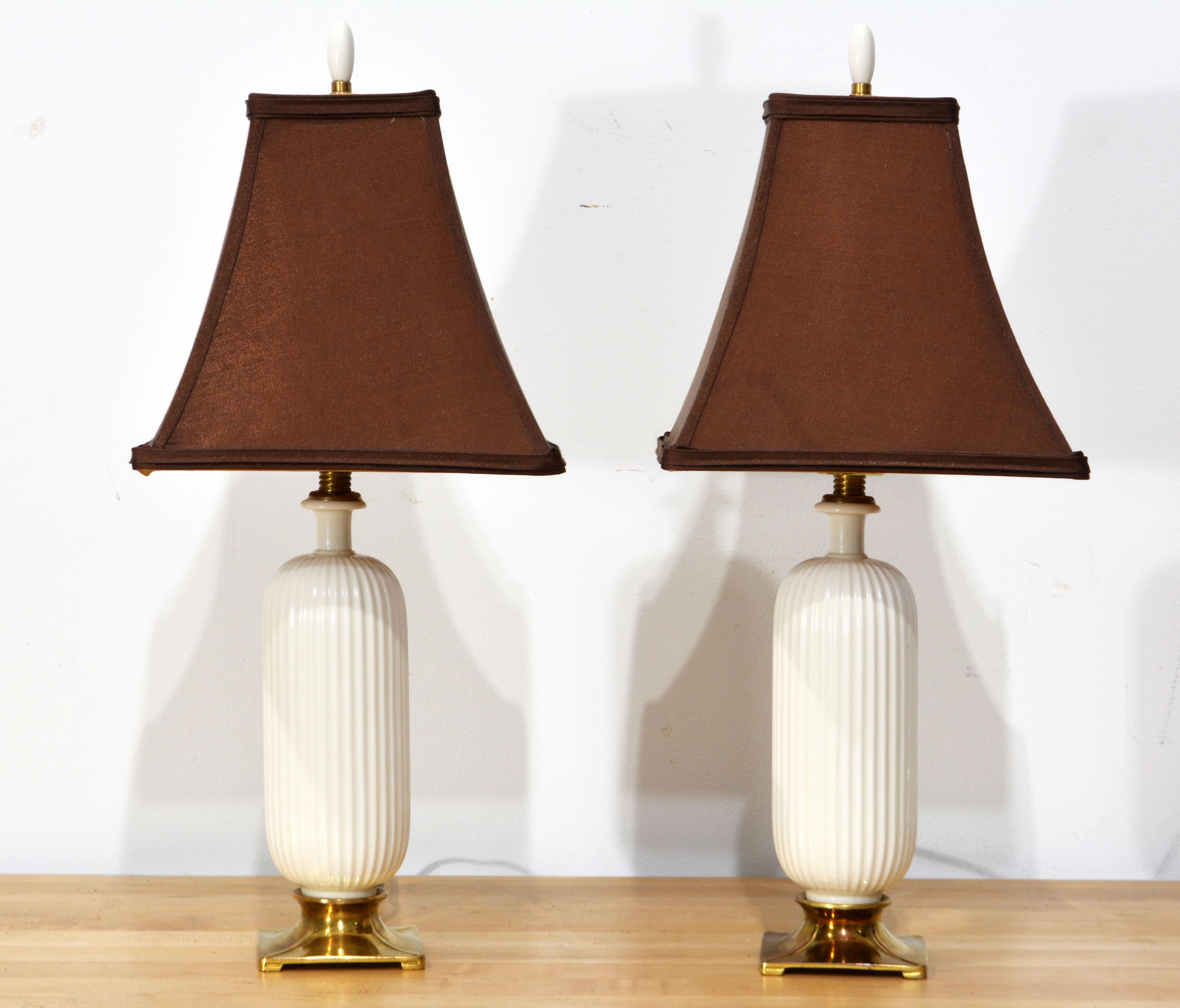 This pair of white glazed (Blanc de Chine) fluted porcelain lamps mounted on square bronze bases and topped by bronze mounts represent timeless elegance. The style is bordering art deco and they likely date to the 1940's-50's. The maker is the New