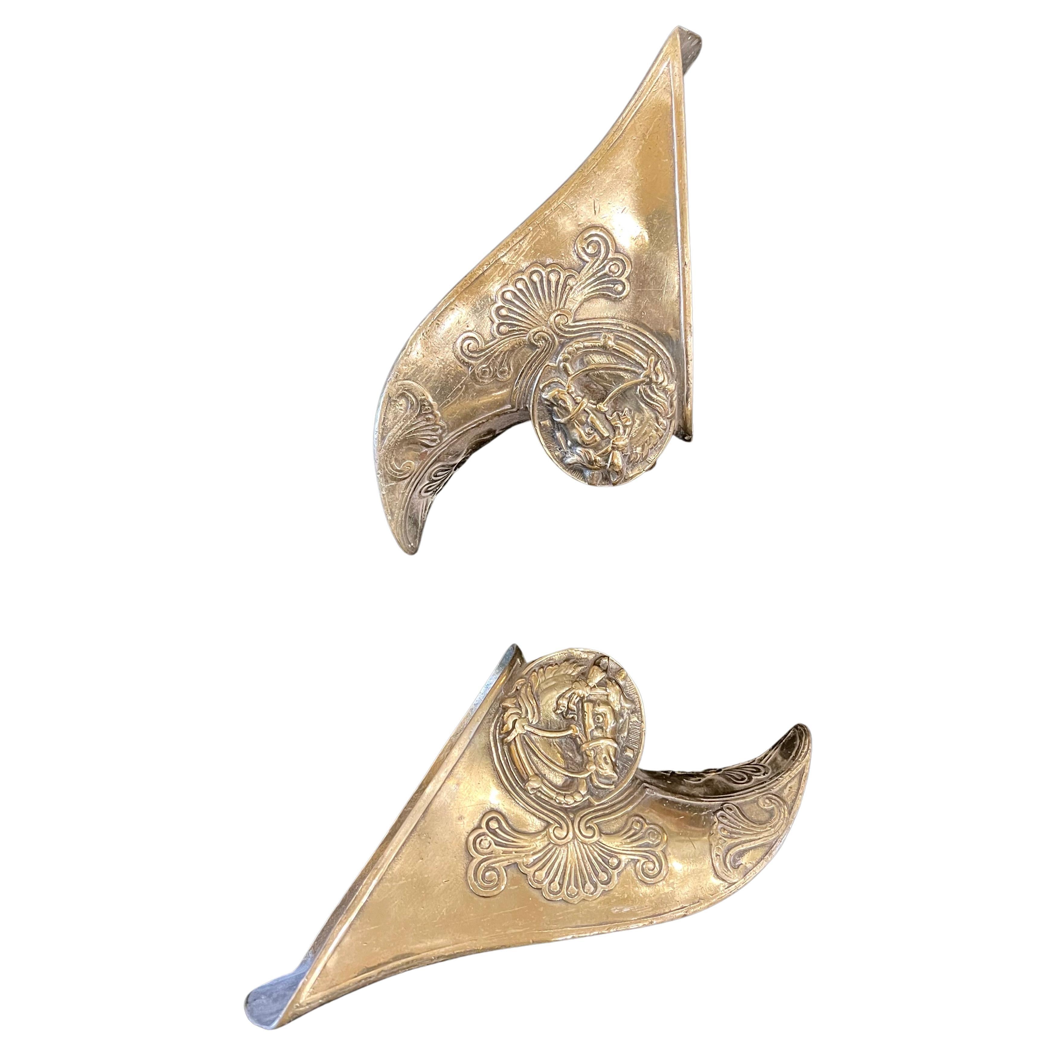 Pair of solid patinated brass stirrups decorative wall hanging pieces.