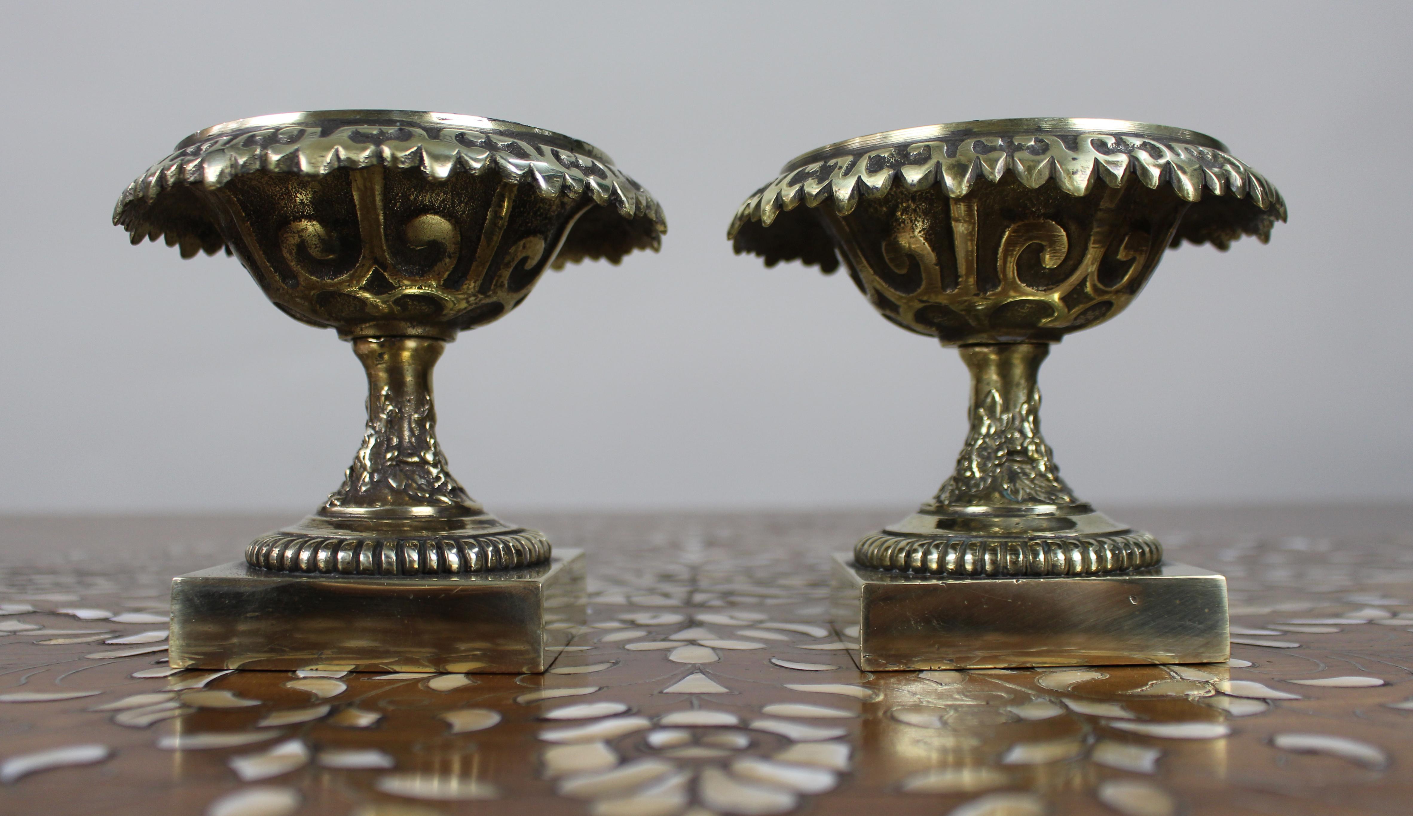 Pair of Decorative Bronze Urns – Grand Tour Style, c.1900

A decorative and well-cast pair of bronze urns, in the classical Grand Tour style.

Each urn features a wide pierced rim with stylised scrollwork, raised on a fruiting vine stem and reeded