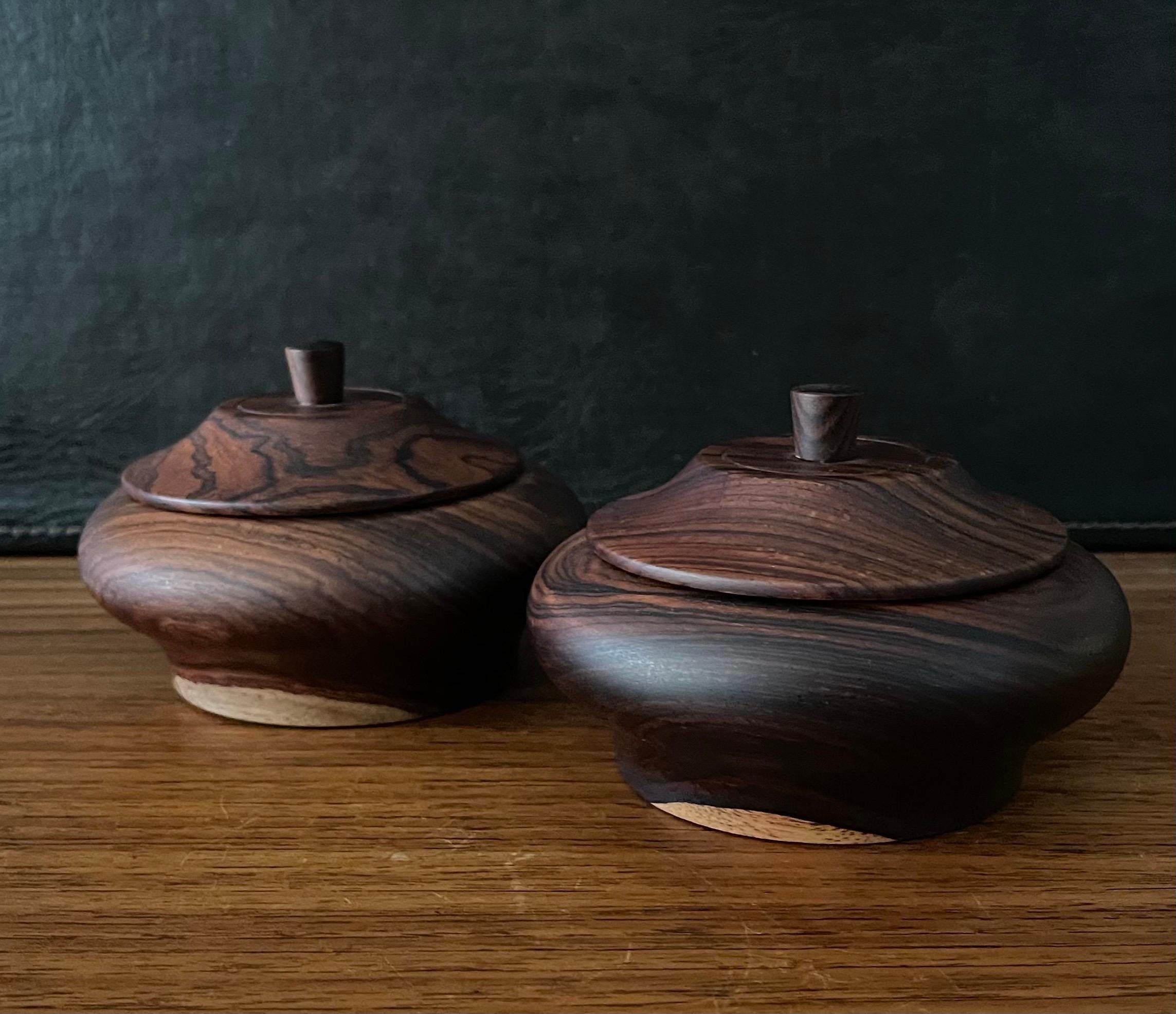Pair of decorative cocobolo / rosewood lidded cannisters from Costa Rica, circa 1990s. The cannisters measures 5