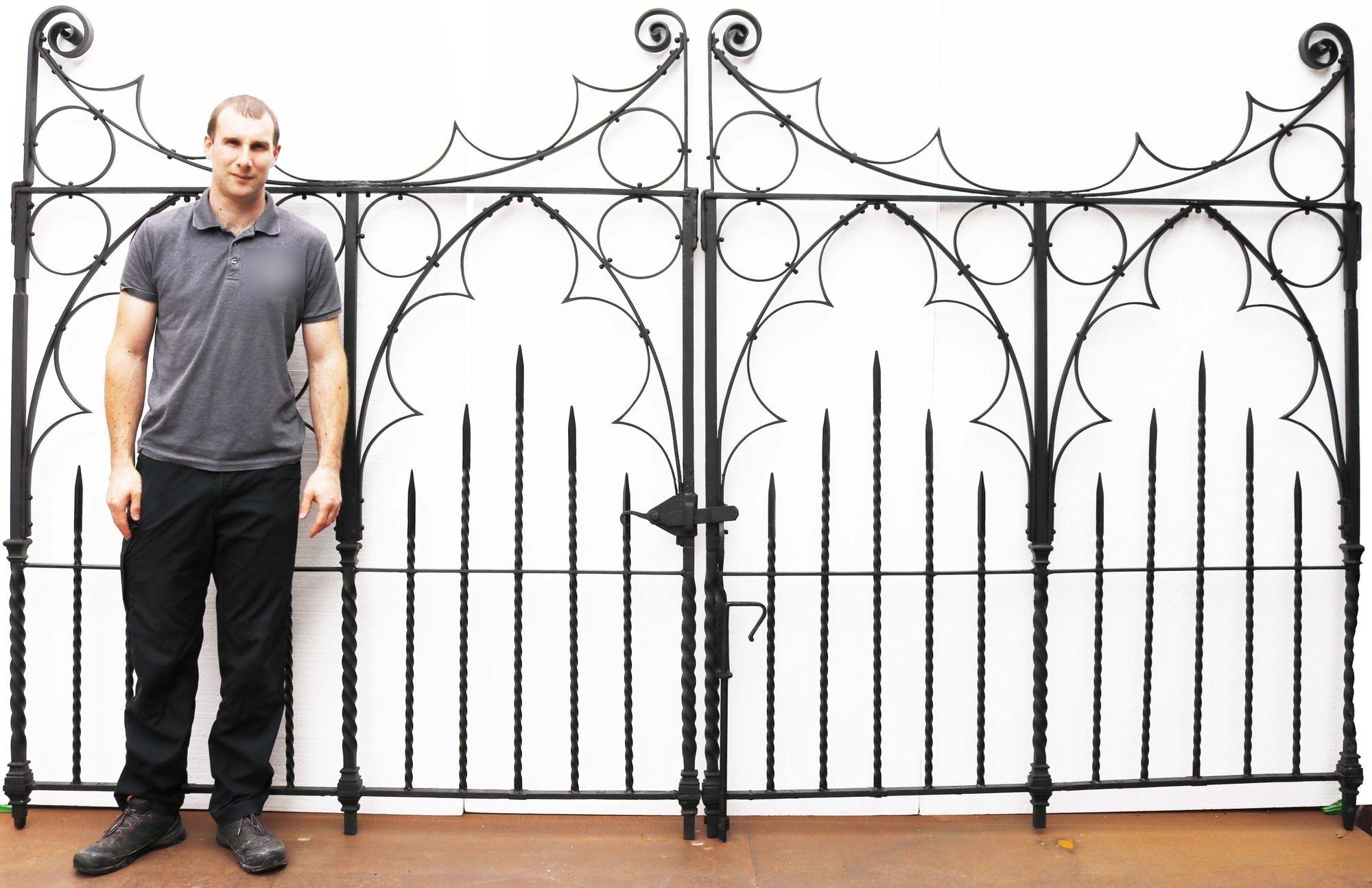 Pair of decorative driveway gates. The gates feature scrolled ends and decorative iron work throughout. They have been shot blasted and primed giving them their grand appearance.