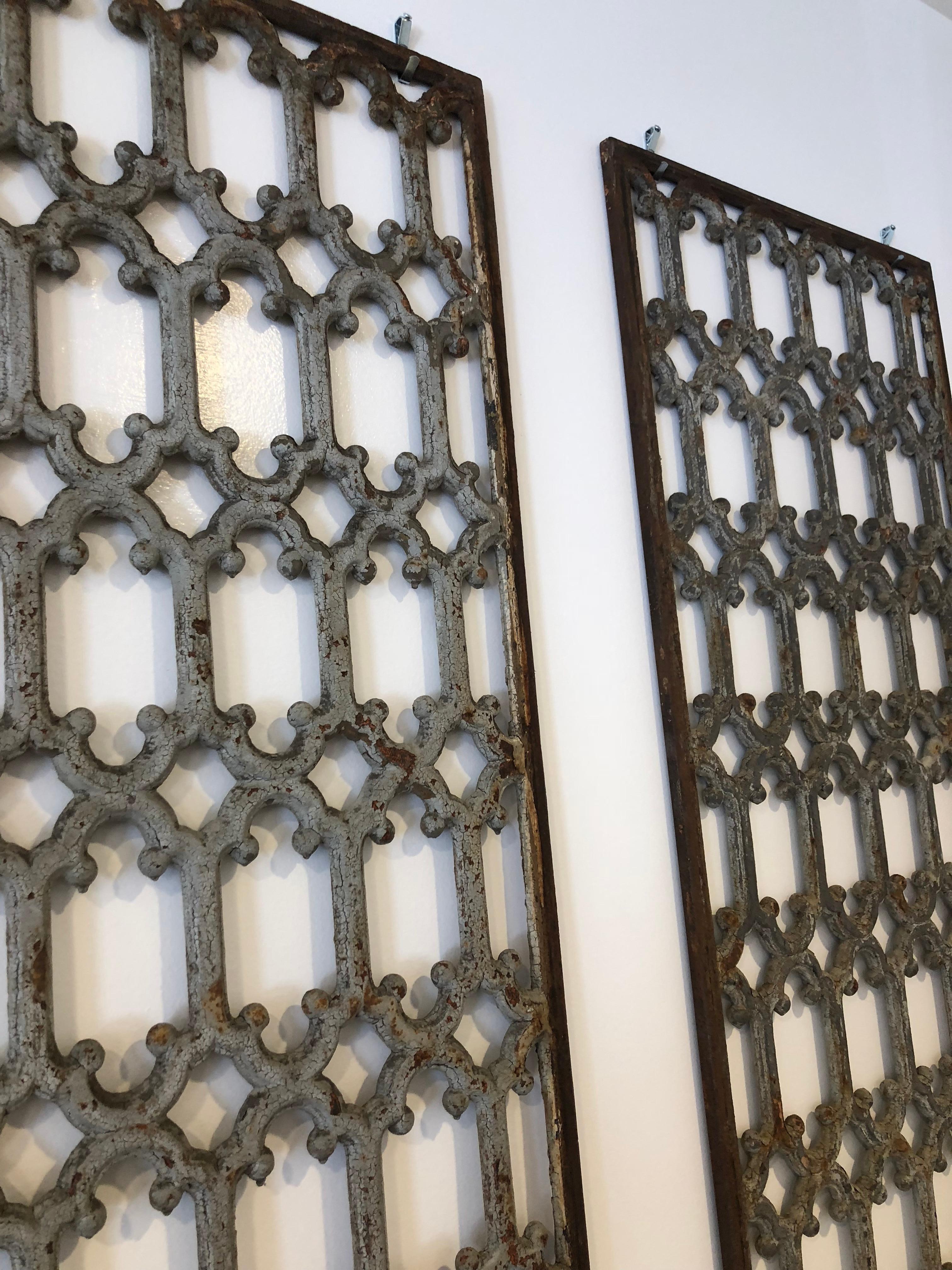 Pair of iron grids with scroll pattern, possible from a gate or window panel. Pretty blue or grey color with patina. They are highly decorative and would work in a variety of settings.