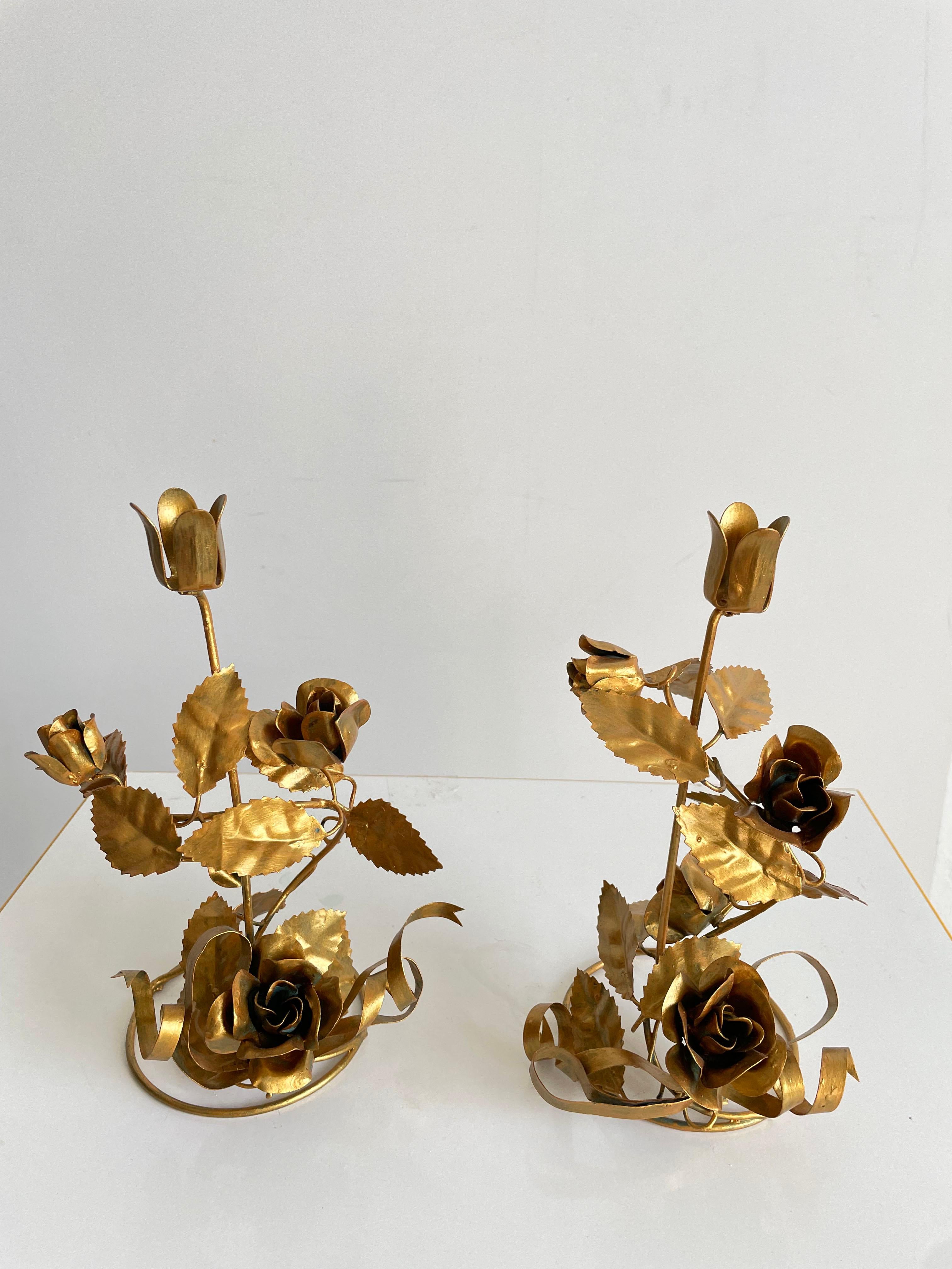 Pair of vintage Italian candlesticks from the 1960s.

Delicate gilt metal floral design, each candlestick has one flower shaped candle holder at the top measuring 2 cm in diameter.

The candlesticks are in very good original condition, with