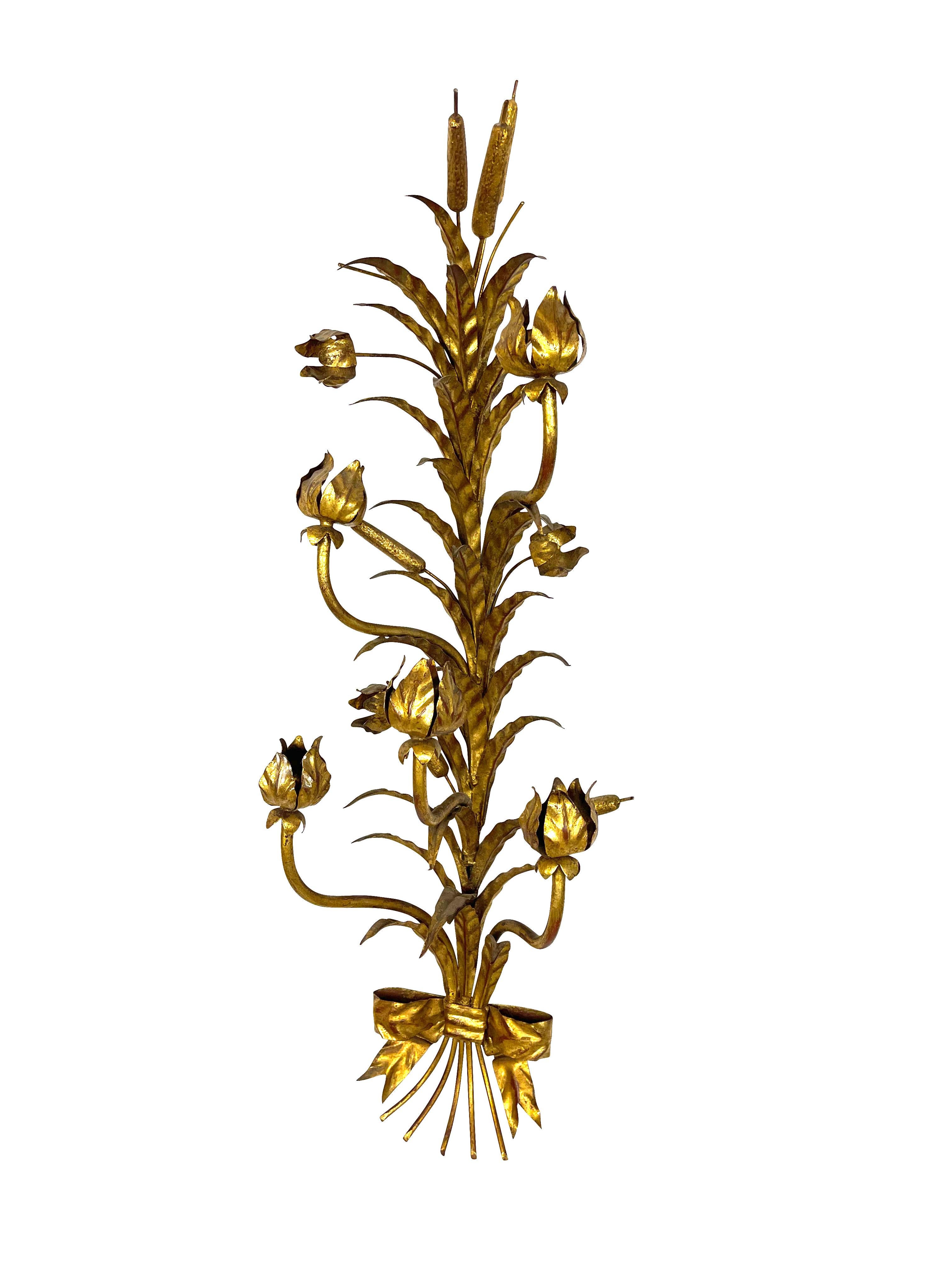 Pair of decorative Italian gilt metal candle sconces with bulrush motif and bow decoration at the base. Candle holders are flower shaped with gilt petals and elegantly curved stems. Lovely on either side of a mirror. Free shipping in the continental