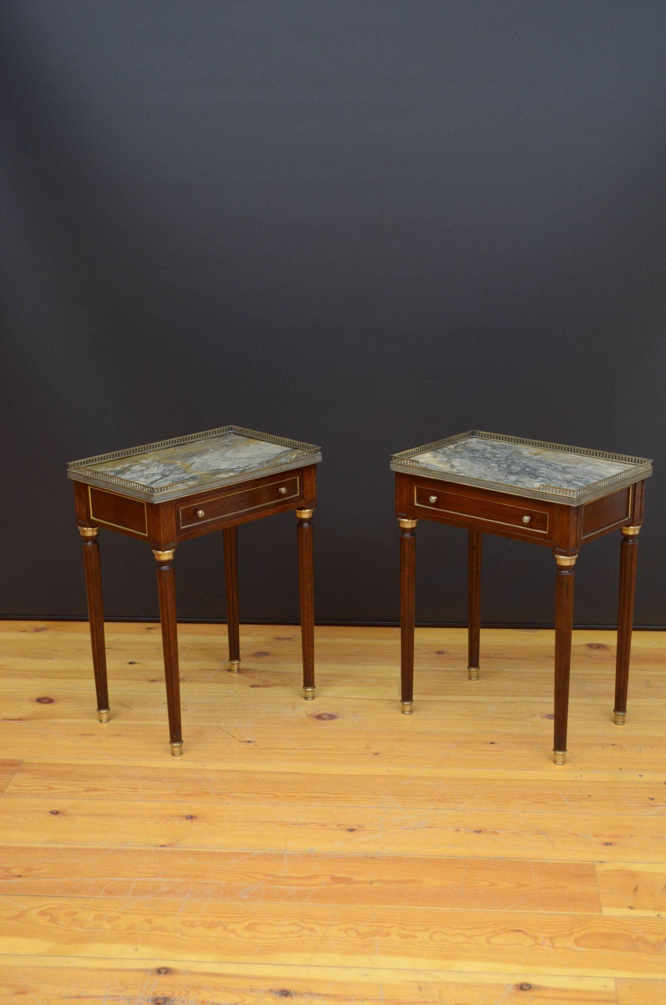 Sn5334 Pair of decorative mahogany tables, each having original marble top with brass gallery above a moulded drawer fitted with original brass handles, standing on turned and reeded legs terminating in brass cups, all with decorative brass