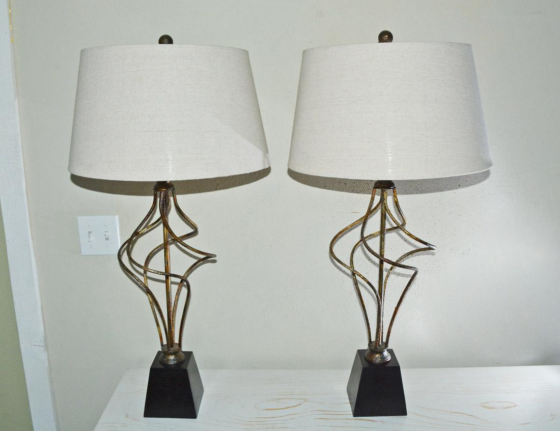 This lamp is comprised of lightly gilded wrought iron freeform spiral with white linen shades.
Measures: Lamp shade bottom - 17.25