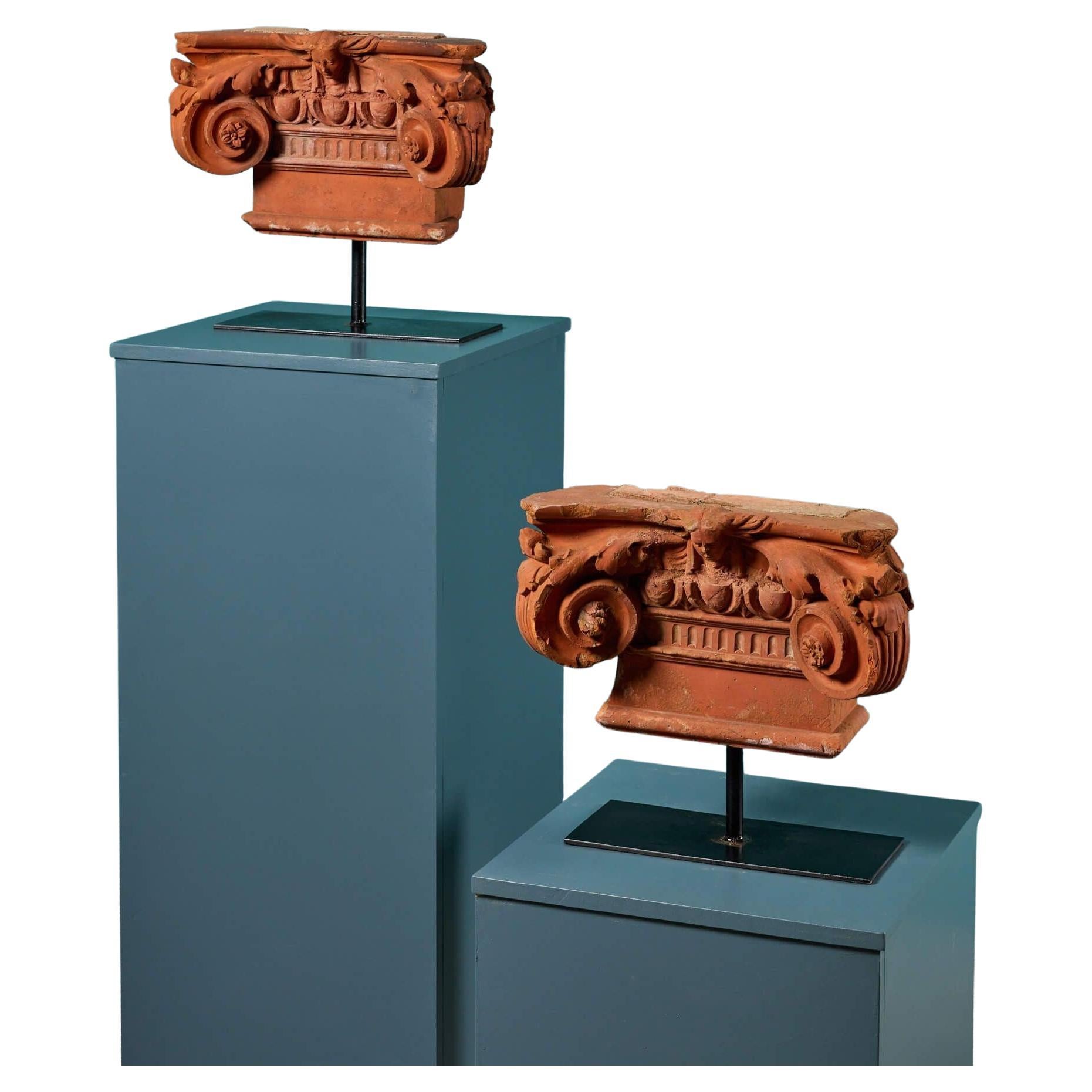 Pair of Decorative Terracotta Ionic Capitals on Stands For Sale