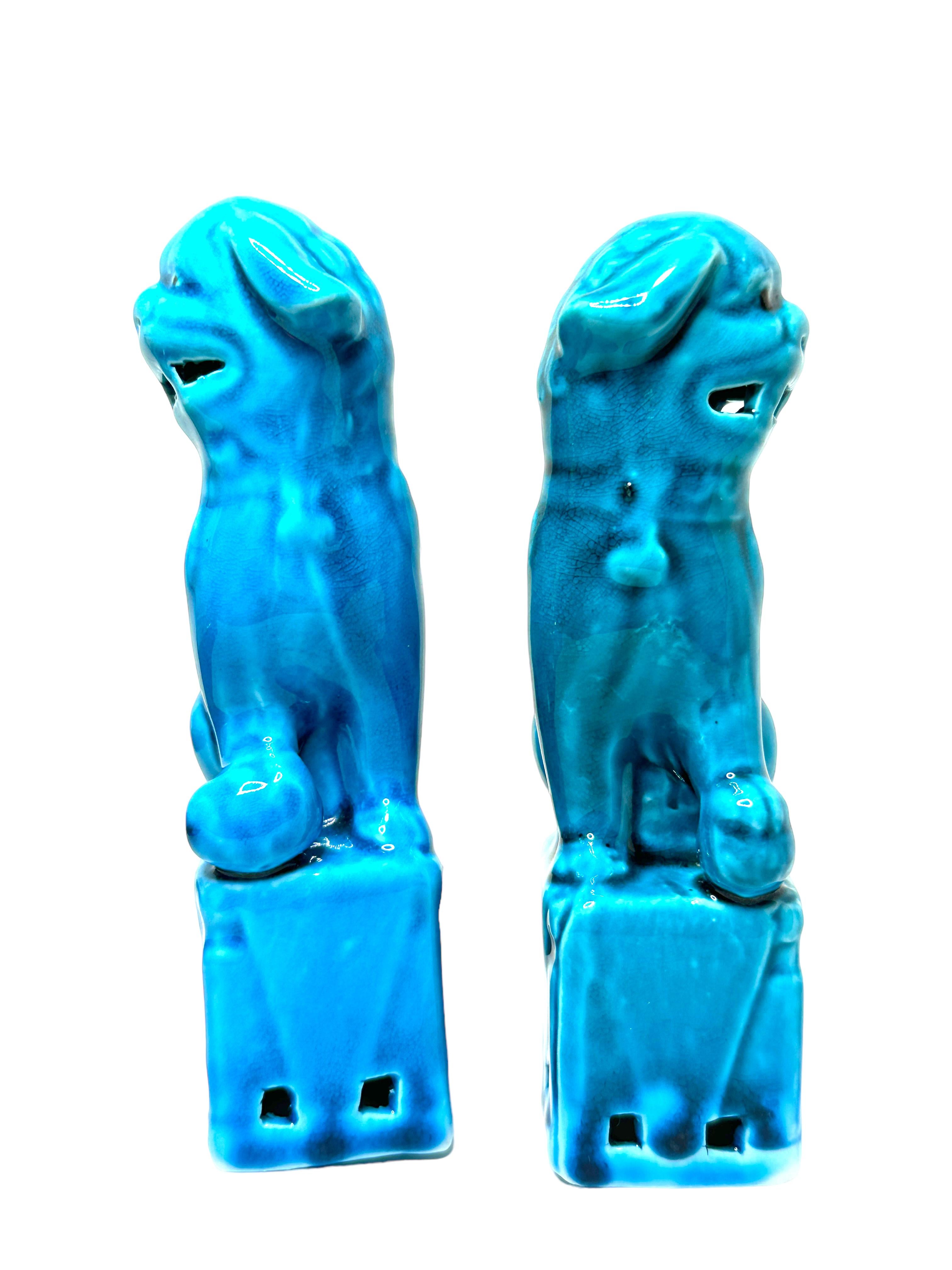 A very nice pair of vintage, turquoise blue, ceramic foo dogs, circa 1980s. Excellent condition and patina; makes a fun decor item in any room!