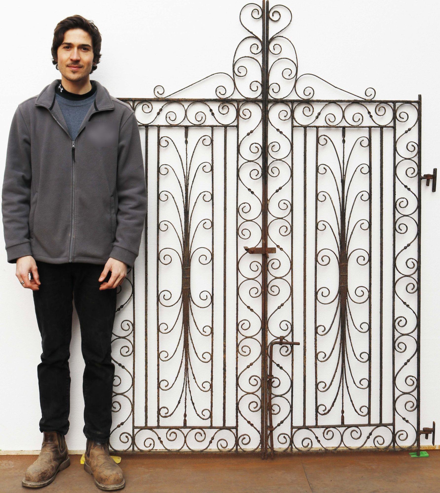 Pair of decorative wrought iron gates. An impressive set of scroll work, wrought iron gates complete with a working latch and their original hinge components.
 
Additional dimensions
Opening of approx. 148 cm.