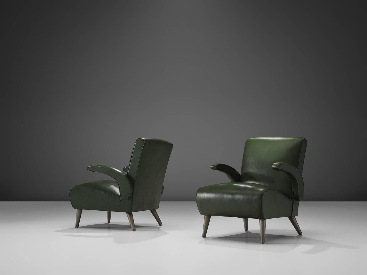 Easy chairs, in green faux-leather and chrome metal legs, Italy, 1950s. 

These mid-modern armchairs are executed in a dark green leatherette. The comfortable easy chairs show voluptuous, round lines. The most iconic feature of this set are the