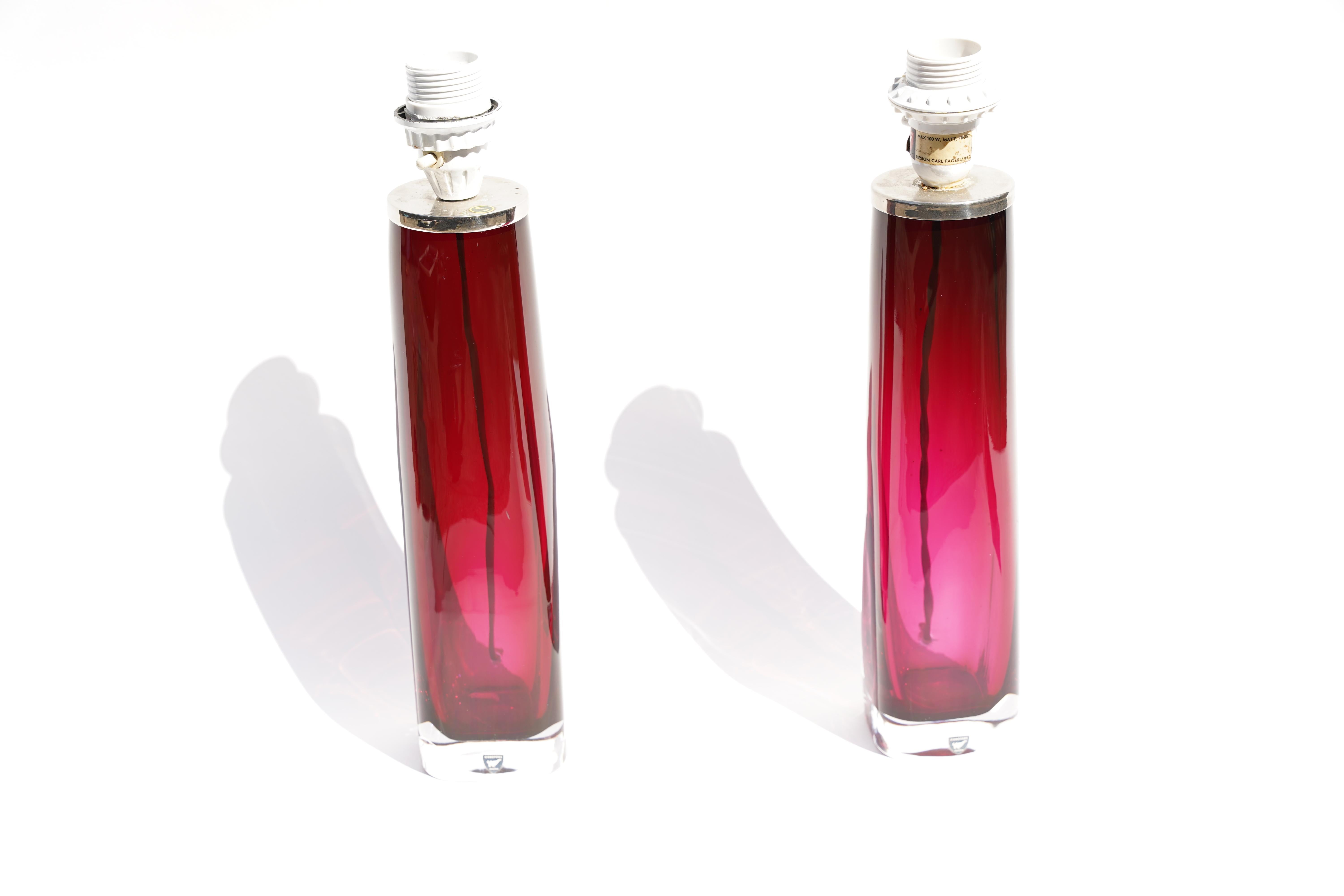 Tall pair of deep pink Orrefors glass lamps with chrome fittings, signed Carl Fagerlund Orrefors on the bottom
The glass body is 13