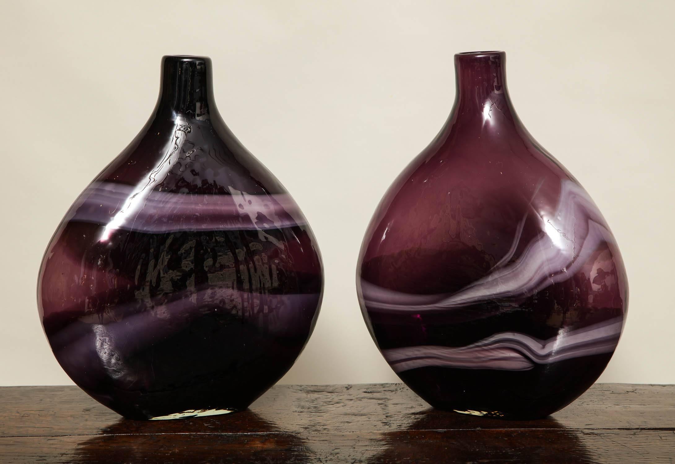 A pair of deep purple studio glass vases having white veining with wide flat bodies and narrow necks. Smoke on the Water? A Fire in the Sky?