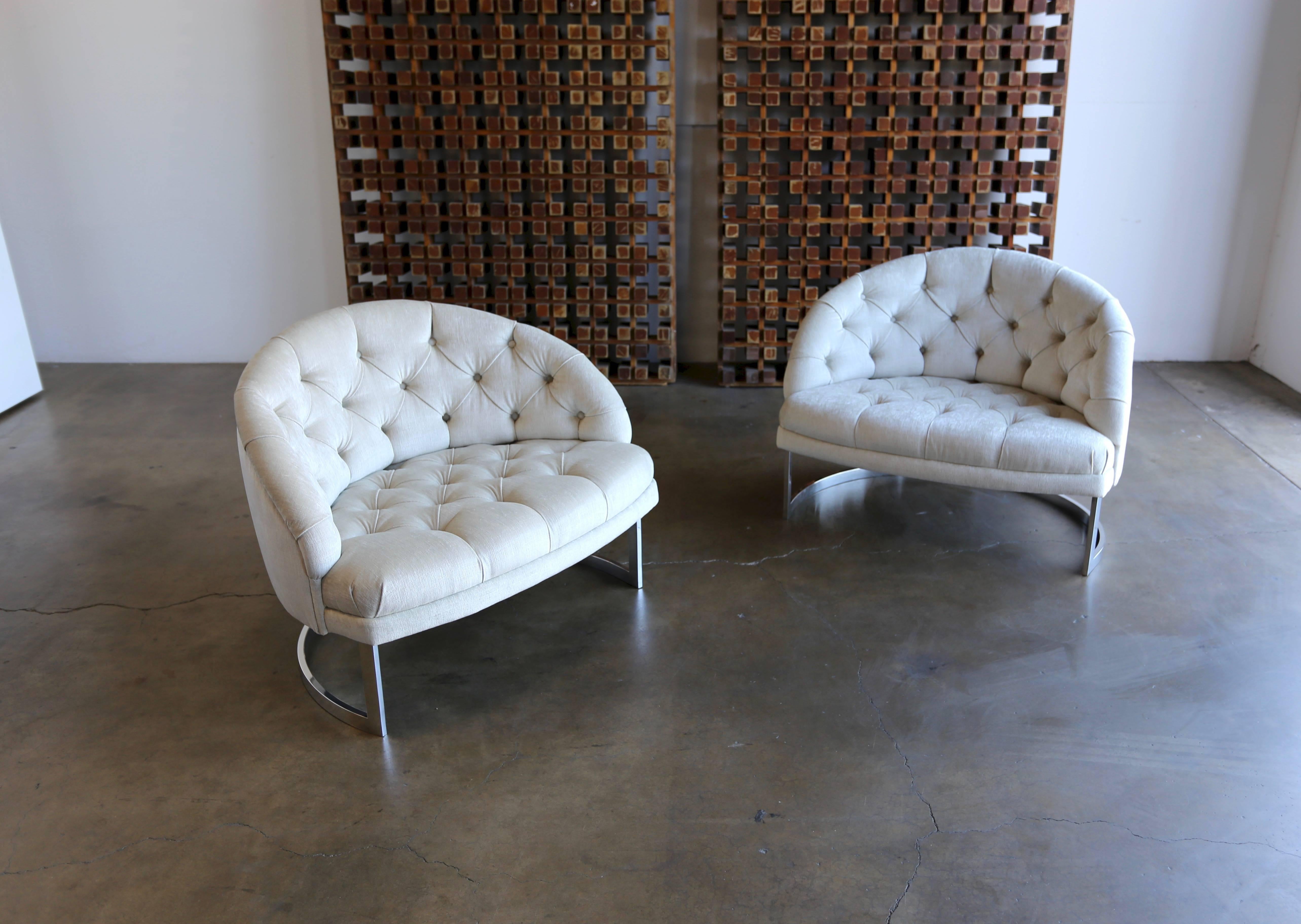 Pair of deep tufted barrel back lounge chairs. This pair has been upholstery in Knoll Summit Chalk fabric. The solid metal bases have been professionally polished.