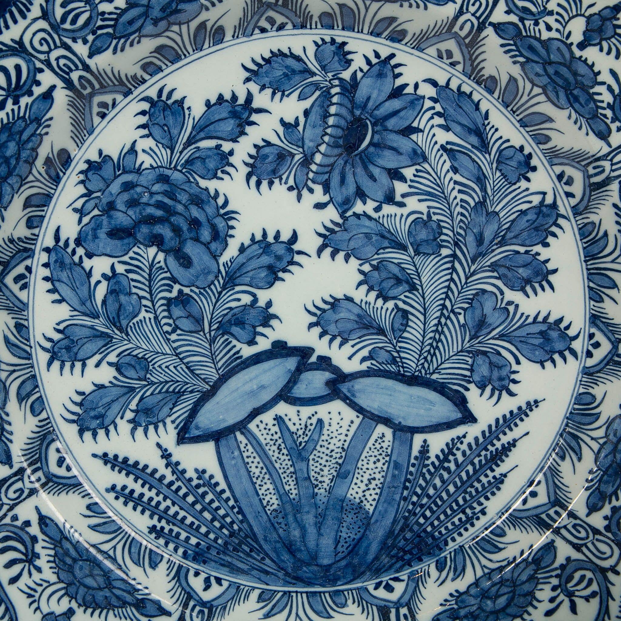 Why we love it: The scene is beautiful and slightly mysterious
We are pleased to offer this beautiful pair of large fully painted 18th century Dutch Delft Blue and White chargers. In the center we see a vibrant, hand-painted garden scene with a