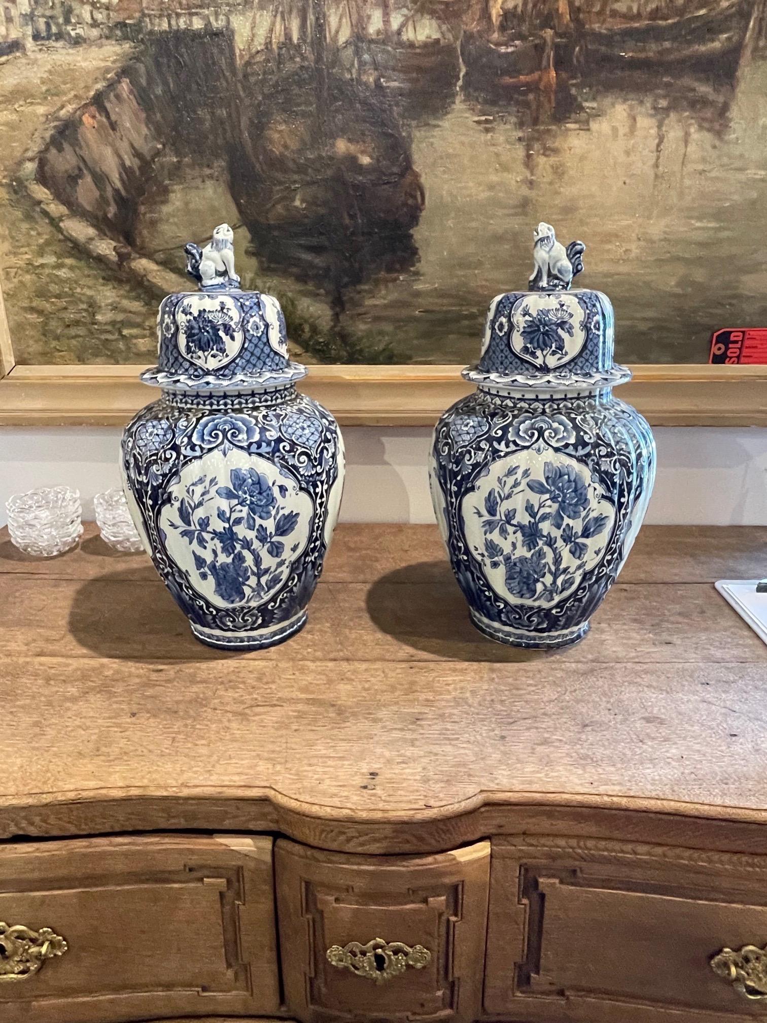 Decorative pair of Delft blue porcelain lidded vases. Beautiful floral pattern in gorgeous shades of blue. A fabulous accessory!!