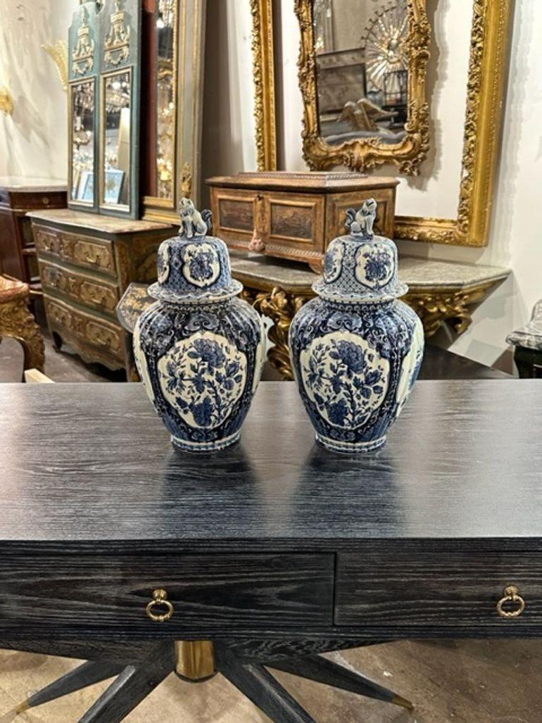 Great pair of early 20th century Delft blue and white covered jars. Circa 1920. A timeless and classic touch for a fine interior.