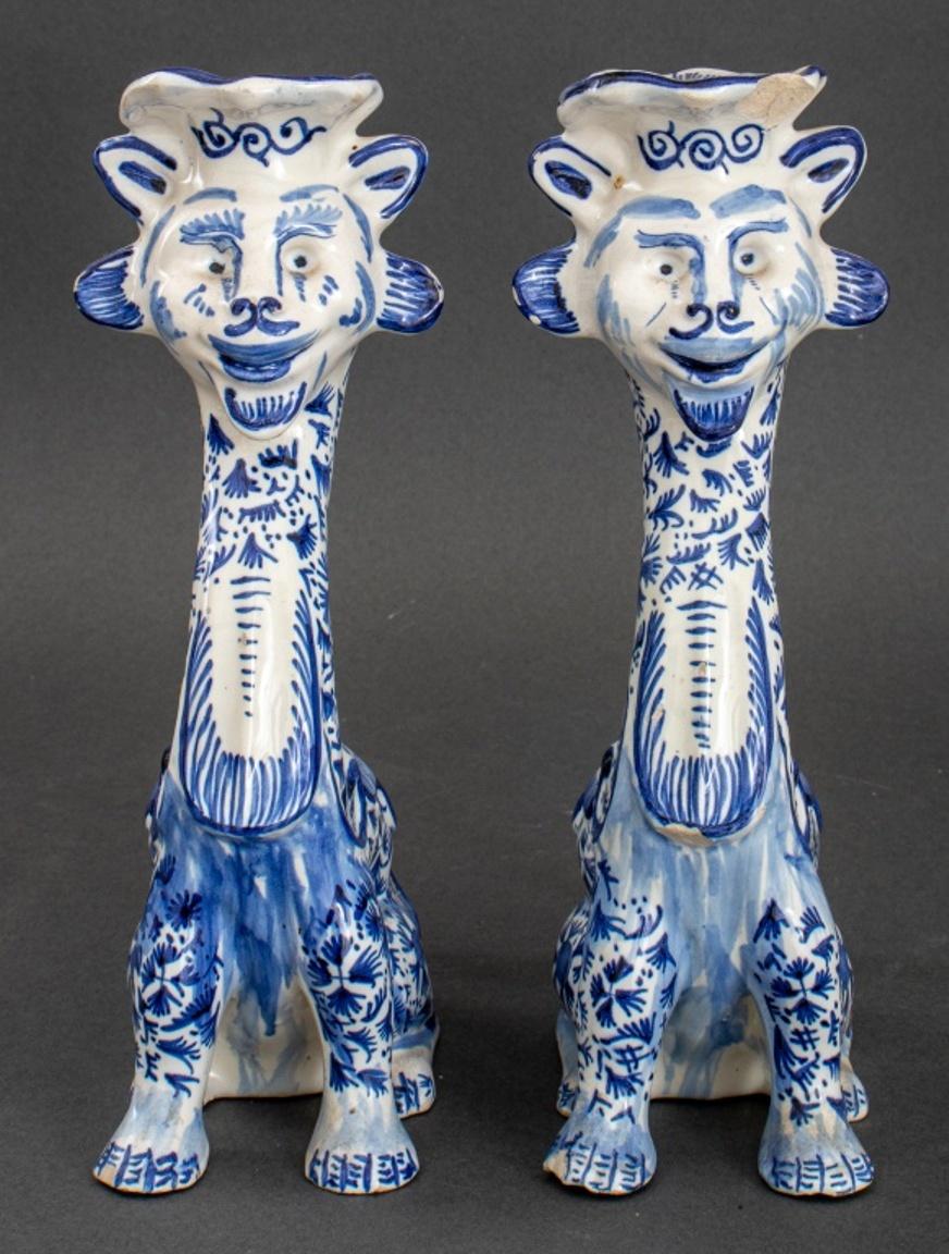Pair of Delft manner blue and white decorated lion form figural candlesticks, each signed 