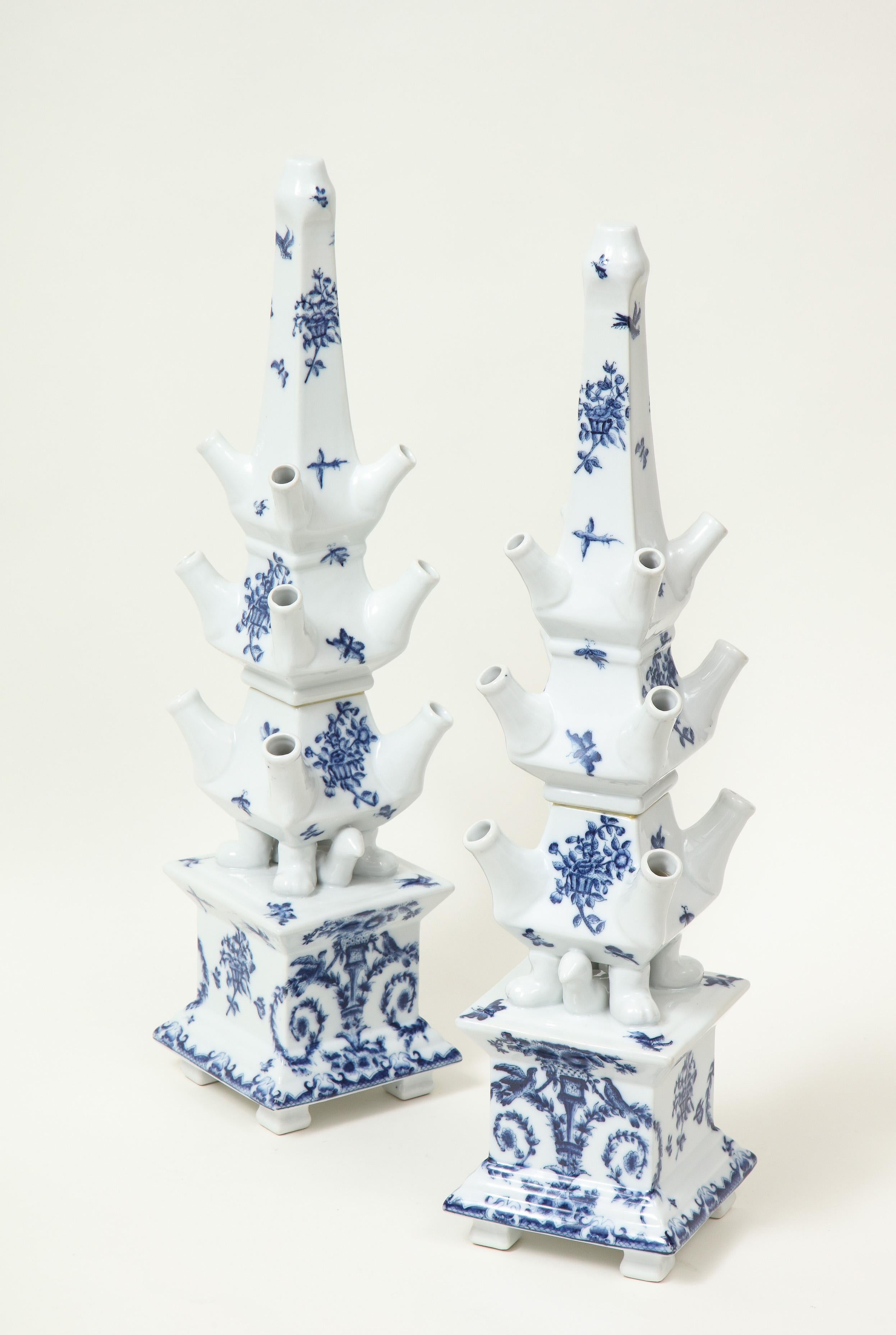 Each of pyramids form with tiers of openings to receive flower stems; decorated overall in blue with baskets of flowers butterflies.

Provenance: From the collection of Mario Buatta and used in one of his show house rooms.