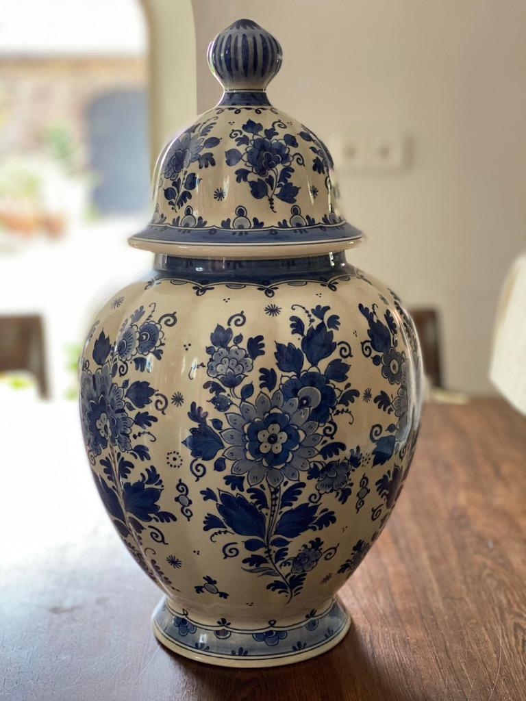 A beautiful set of two mid-Century Dutch Delft lidded ginger jars by Zenith Gouda. Maker's marks on the reverse. These stunning vases are a nice large size with a wonderful ribbed shape, blue and white floral motif, These jars are from the same line