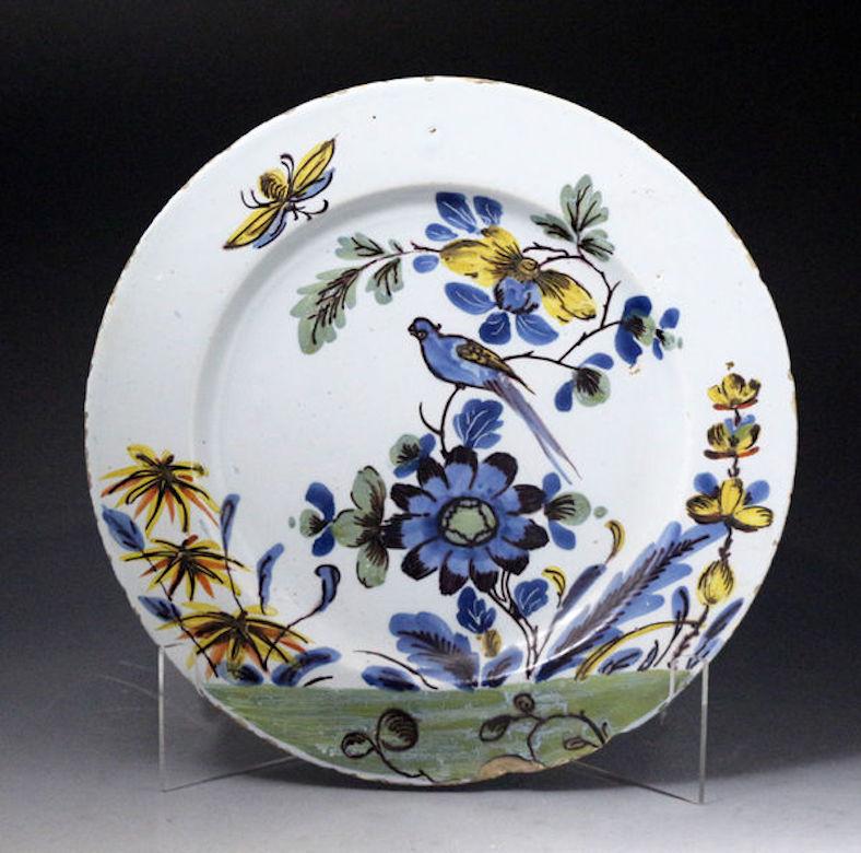 Pair of Delftware polychrome decorated chargers of exceptional quality mid-18th century. An excellent pair of delftware dishes decorated with birds, flowers, and insects in polychrome colours. The rare pair have wonderful decorative appeal and are