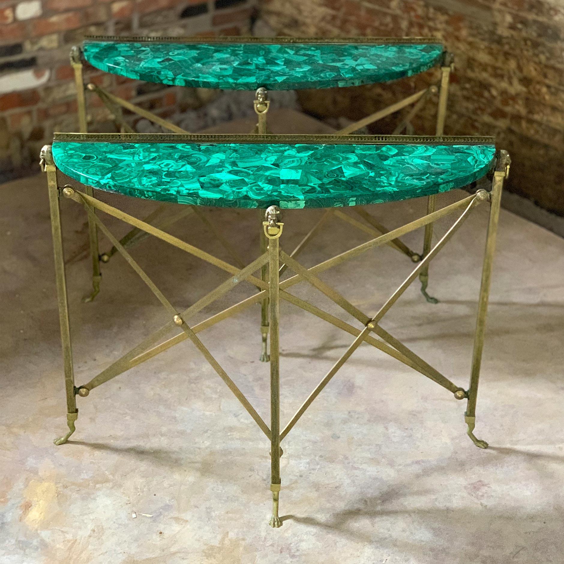 A truly stunning pair of 1950s demilune brass console tables attributed to Maison Jansen, with Malachite marble tops, lion heads and paws.