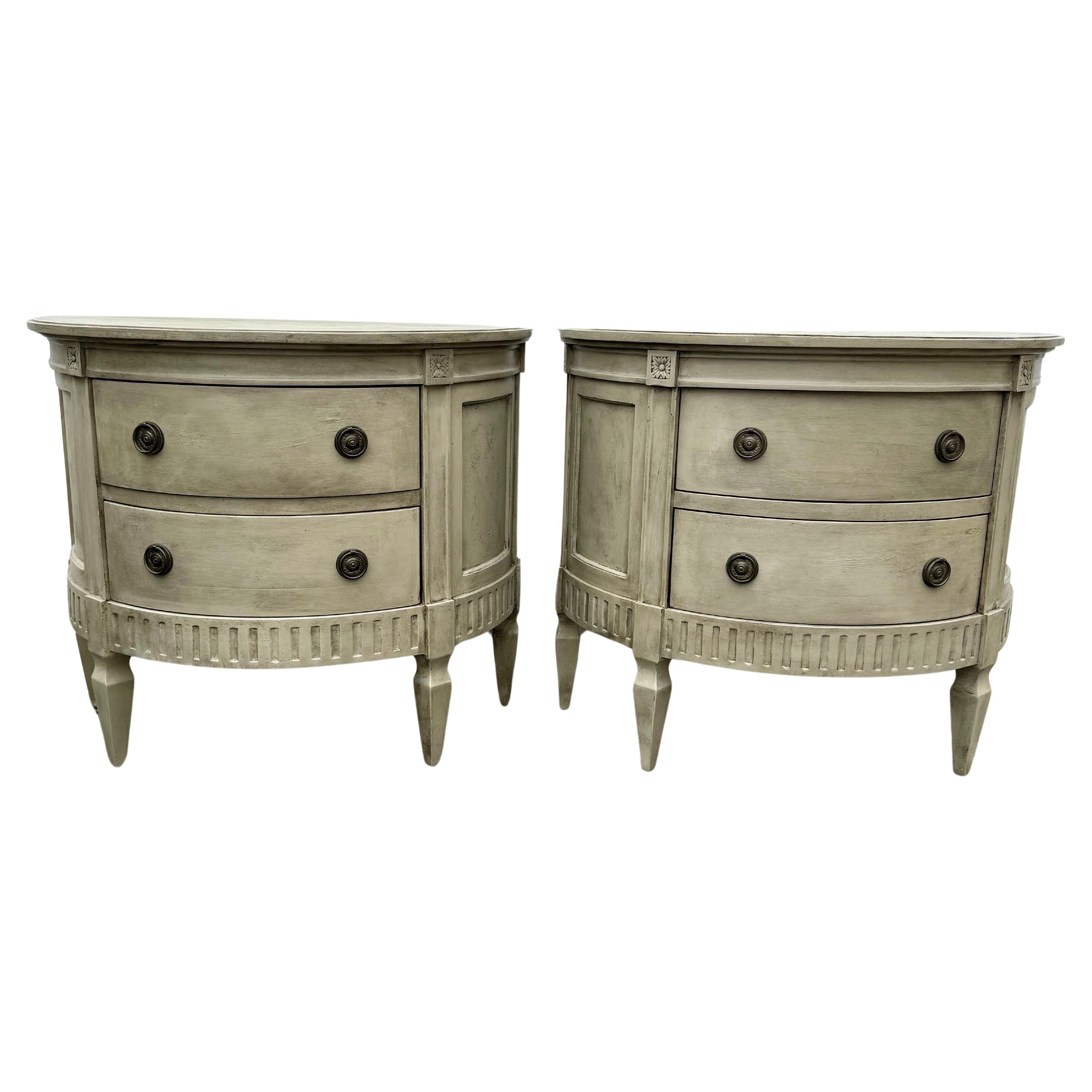 Swedish Gustavian Style Painted Chest of Drawers, A Pair

This classic Swedish style two drawer carved and hand painted neutral gray toned demi lune chests or tables have been constructed from solid wood. Wonderful details on this set including a