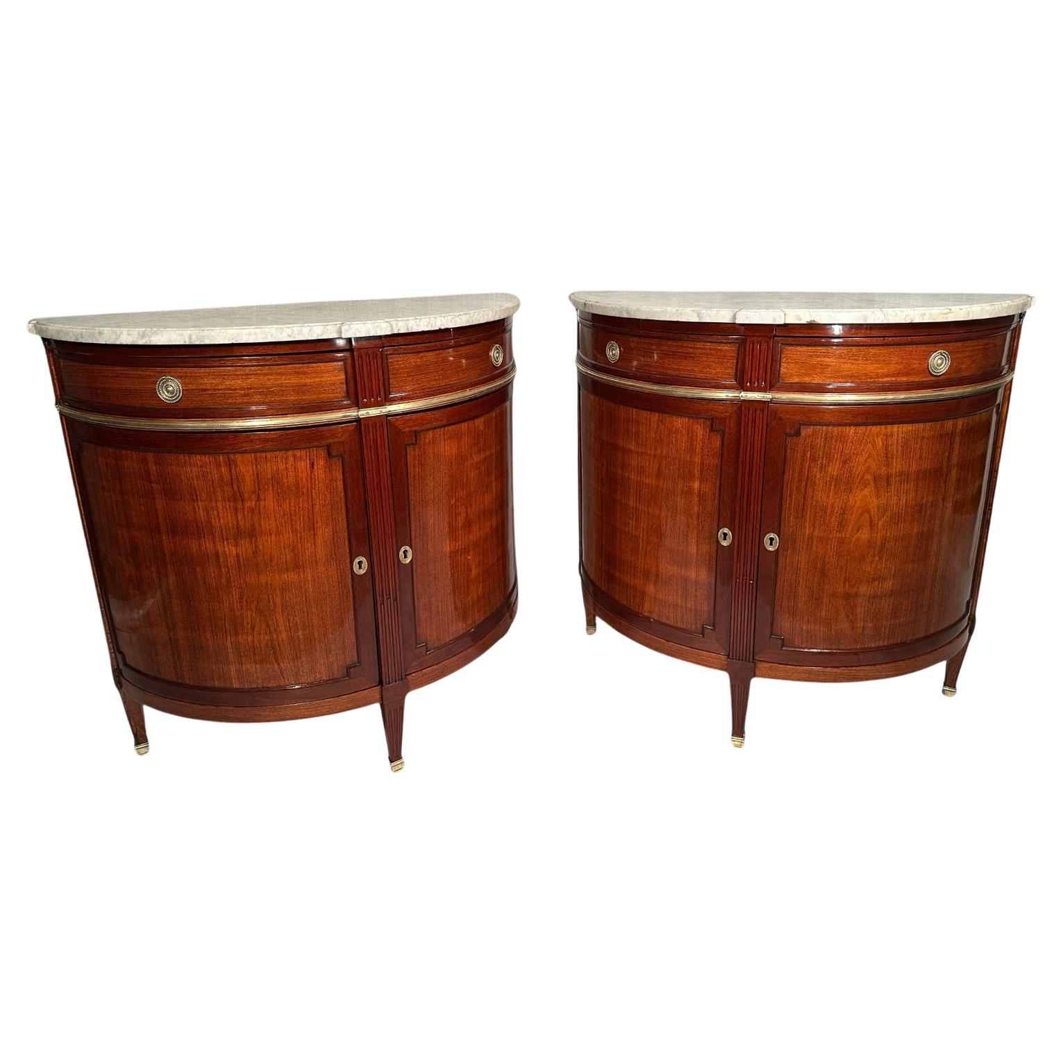 Elegant Pair of Demilune Cabinets, 1800
Discover this beautifully refinished pair of Demilune cabinets, crafted in France around 1800. These rare, matching cabinets feature mahogany veneer on sturdy oak, fluted legs, and a central rabbet ledge,