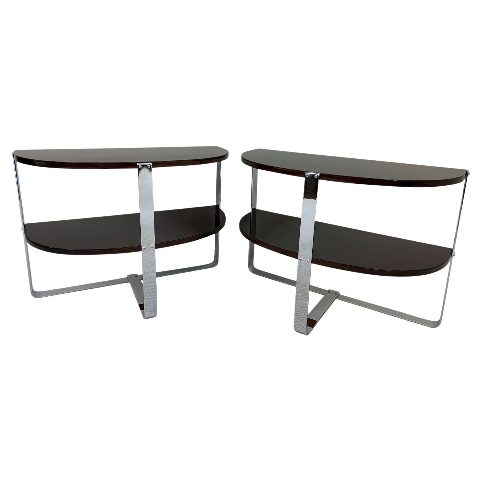Pair of demilune chrome and walnut side tables in the style of Donald Deskey. Beautiful pair of professionally restored and re-chromed Machine-Age tables with two shelves perfect for any room or sitting area. Possibly produced by Ypsilanti Reed