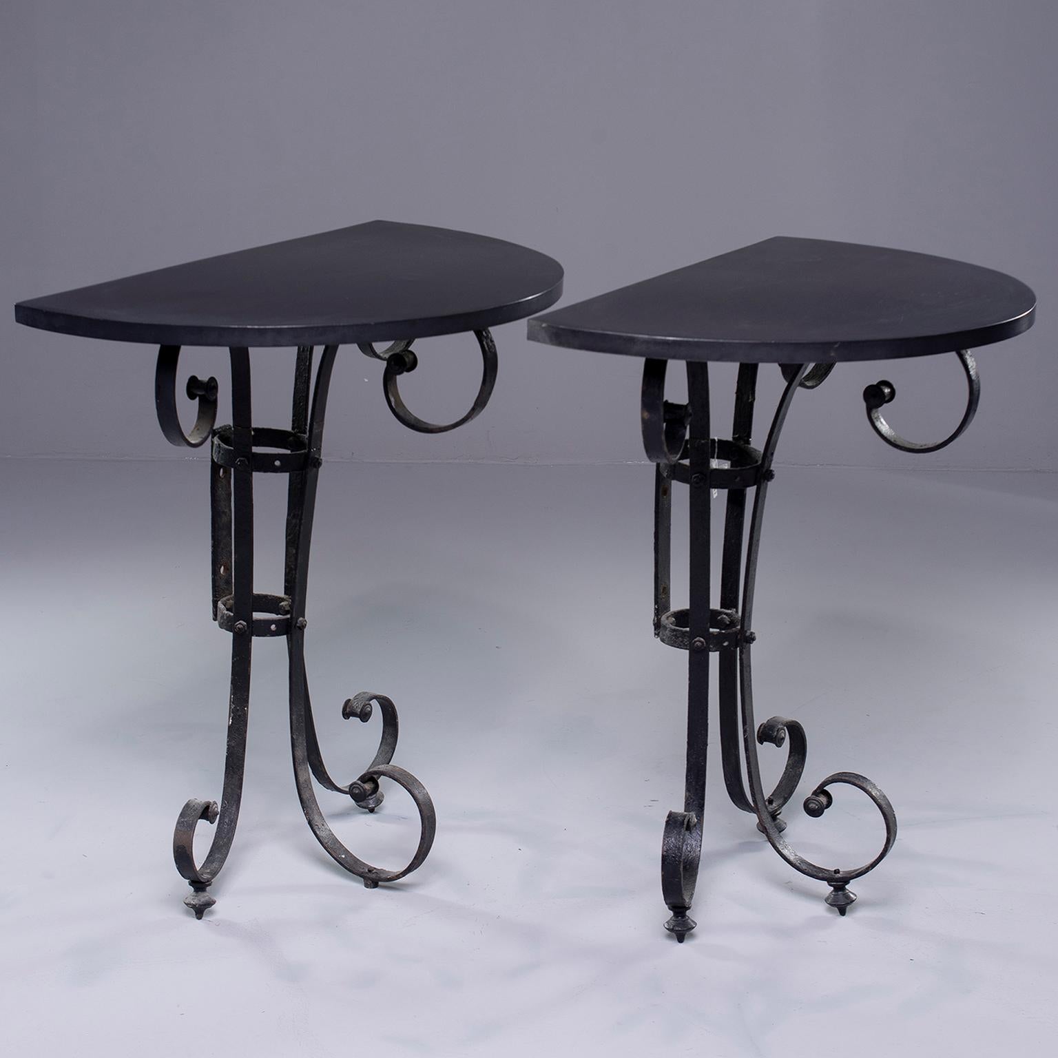 Pair of small Italian demilune shaped console tables made with iron base of late 19th century Italian candelabra and topped with new, custom made matte black metal tops. Sold and priced as a pair.