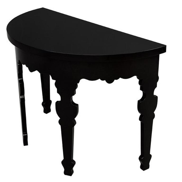 Here we have a pair of stylish black lacquered demilune console tables. Made in the USA, they have been finished in a high gloss black and will suit any contemporary setting. The finish on these consoles was hand-rubbed to give it its brilliant