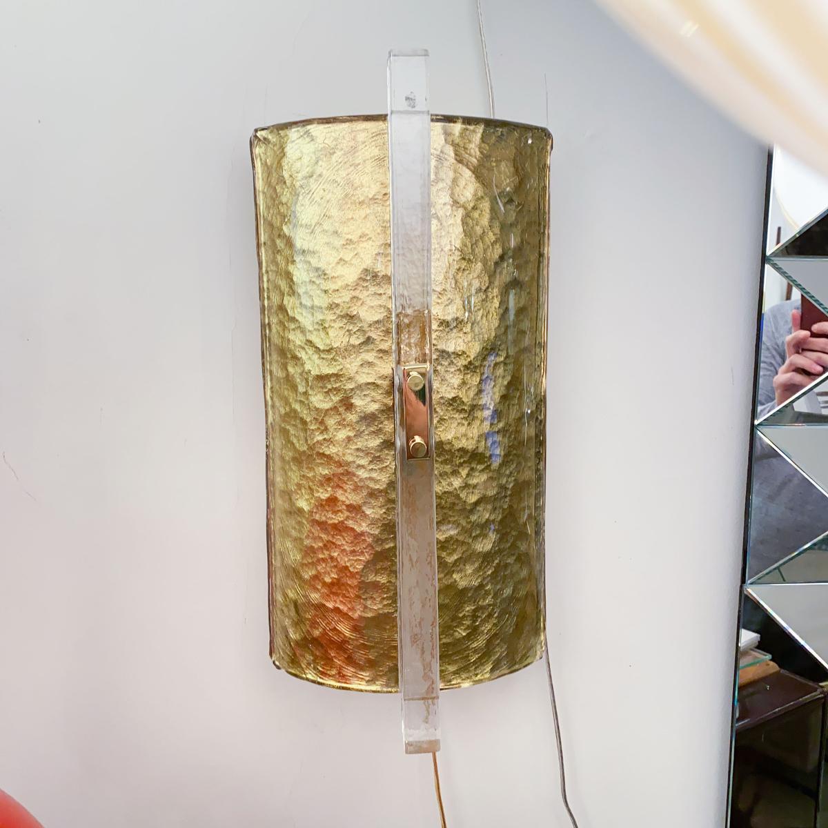 Pair of icy Murano glass sconces featuring a reverse leafed demilune shade. Three pairs available in gold and one pair available in silver leaf.