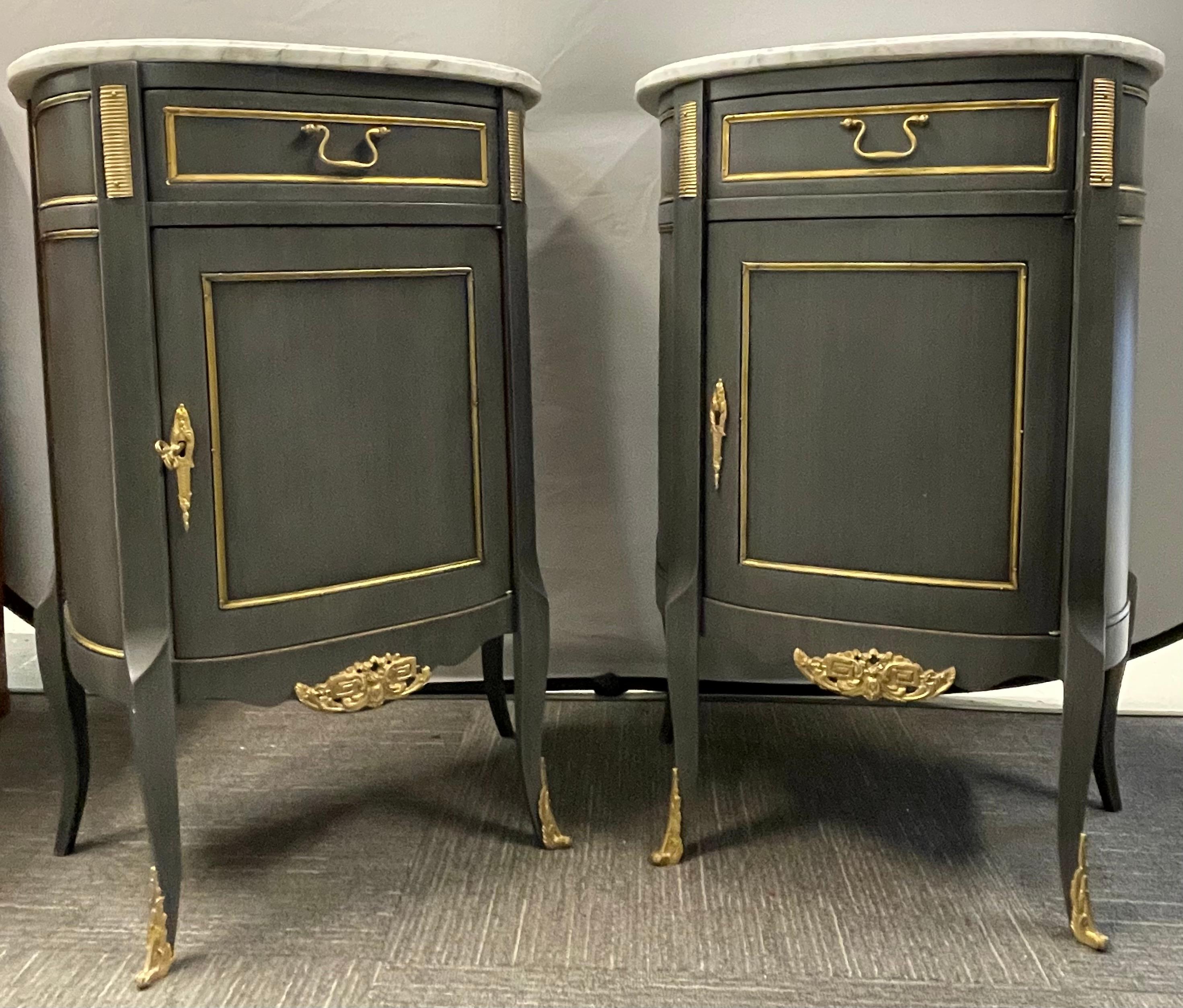 A finely constructed pair of green blue painted marble top Louis XV style nightstands, side tables or/ end tables. Each in the Louis XV style with bronze mounts and marble tops. The demilune painted cabinets with a single shelved door under one