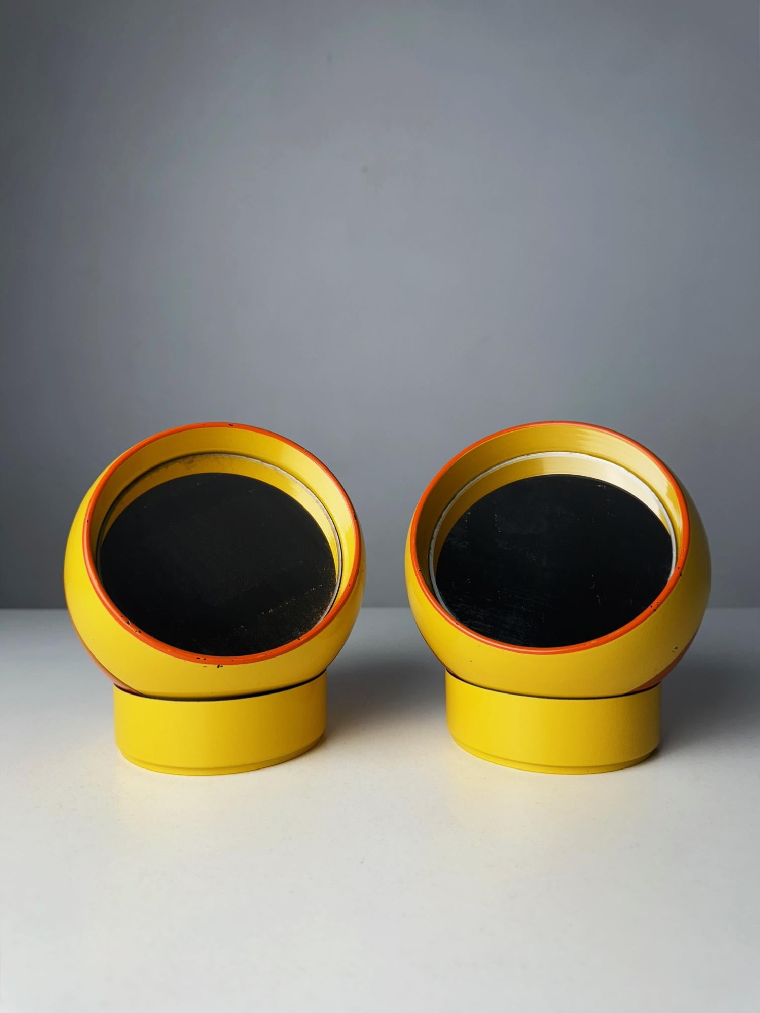 Pair of Dennie-O Space Age Mirrors with Secret Compartments (1970s)

Add a touch of retro-futuristic charm to your space with this pair of Dennie-O Space Age mirrors from the 1970s. These iconic yellow spherical mirrors are a perfect example of