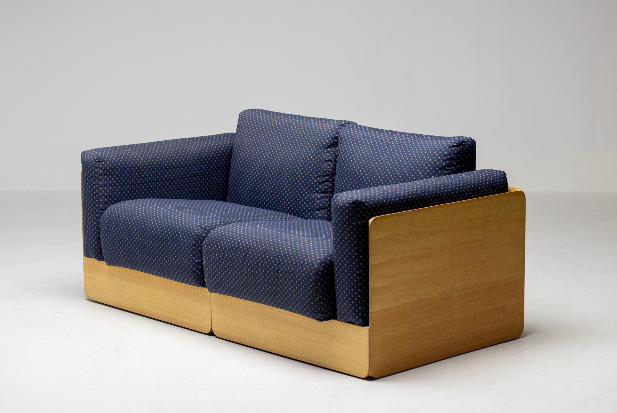 Comfortable pair of two-seater sofas designed by Derk Jan de Vries for Domus.
Ash plywood frame with trademark rounded edges and loose cushions upholstered in fabric.
The sofas have wheels at the rear to move them around easily. 
Two available,
