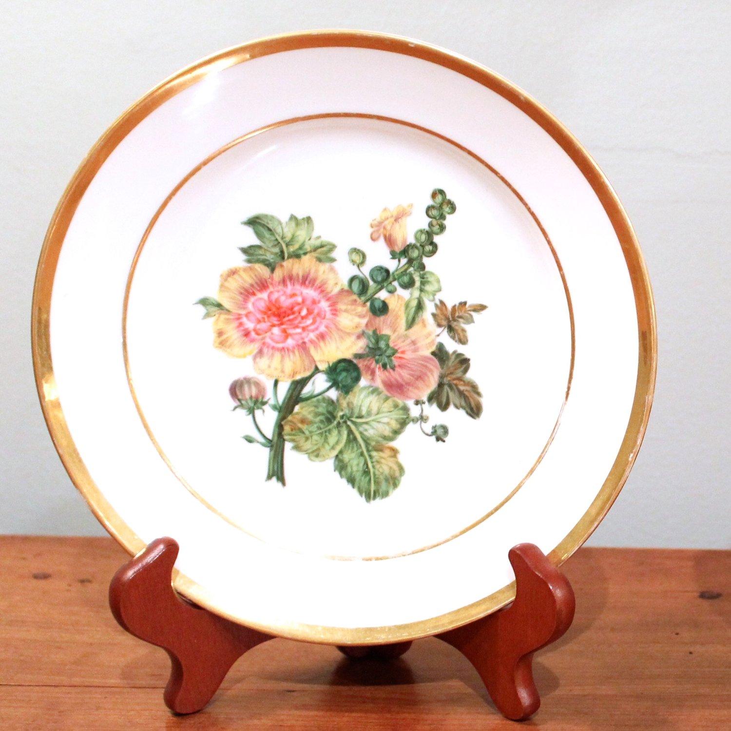 A fine pair of painted Paris Porcelain plates with gilt rims, one with a hollyhock, the other with a spray of various flowers including roses and Larkspur exquisitely painted. Provenance: private collection, prior to that, fine porcelain dealer