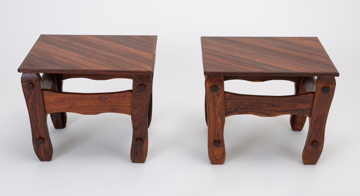 A pair of side tables from Don Shoemaker’s “Descanso” line produced in highly figured cueramo wood. The blocky construction and broad planes of the frame showcase the almost marbled appearance of the woodgrain, while the wavy edges and exaggerated