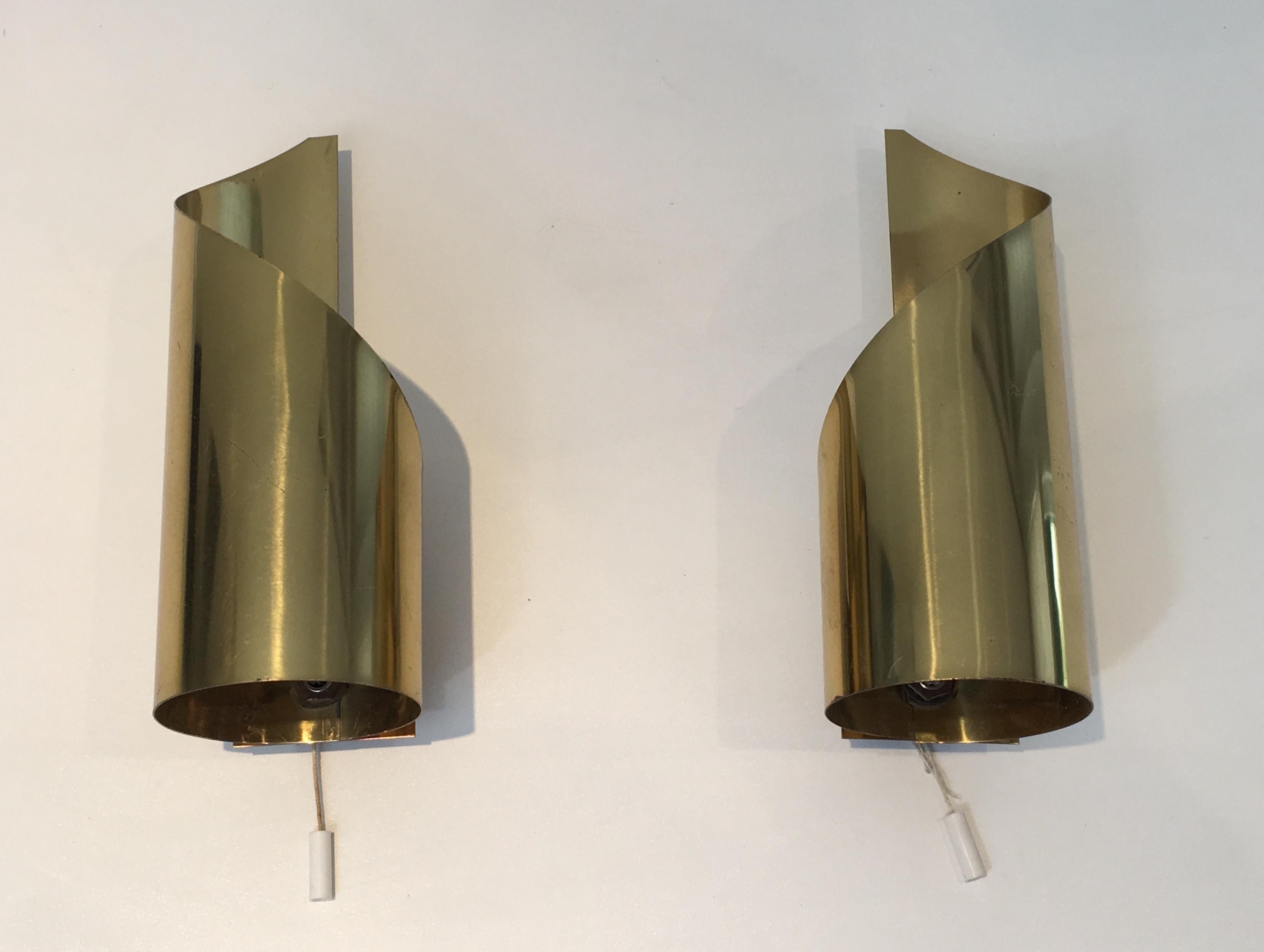 Pair of design brass sconces made of curved sheets of Brass. Circa 1960.