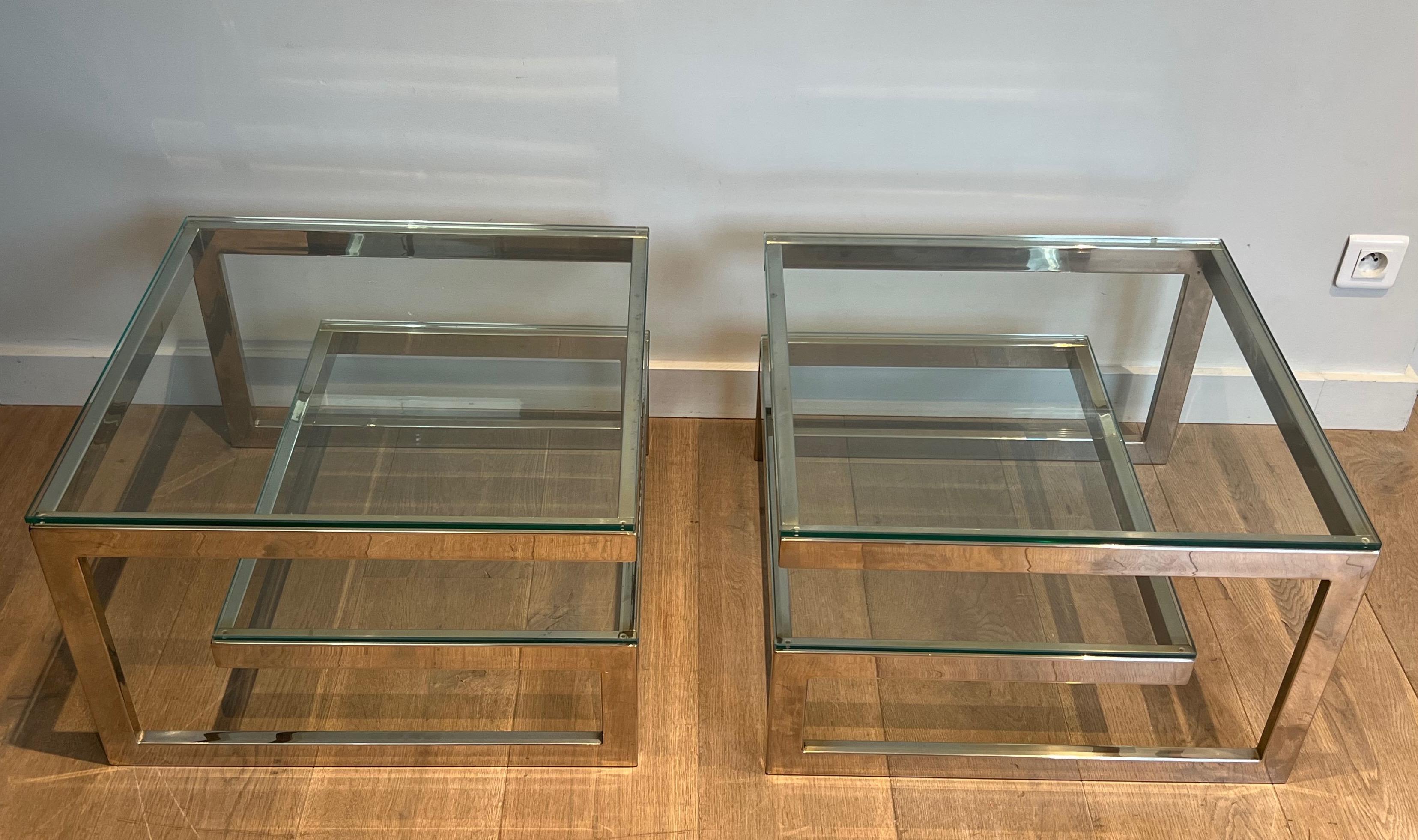 This pair of very nice design side tables is made of chrome with thick glass shelves. This is a French work, circa 1970.