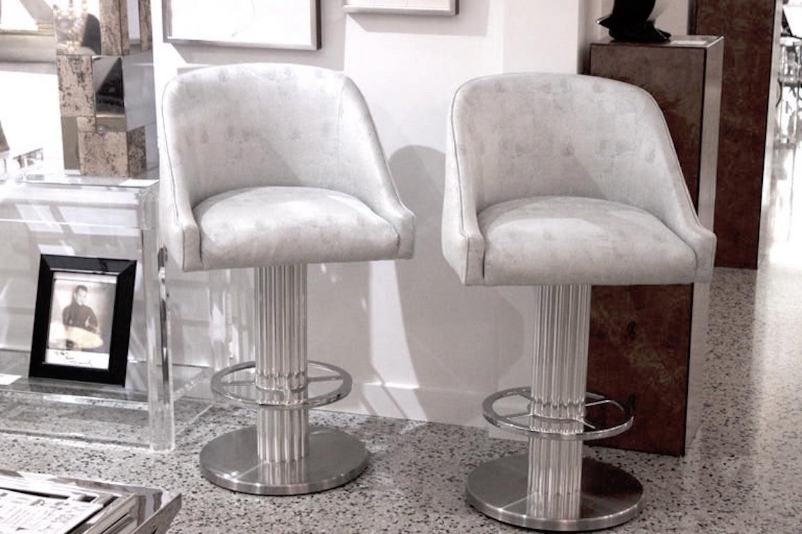 This pair of design for Leisure Art Deco Machine-Age style memory swivel bar stools will make the perfect perch for you and your guest.

Note: These pieces have been recently upholstered in a woven, textured silk blend fabric with