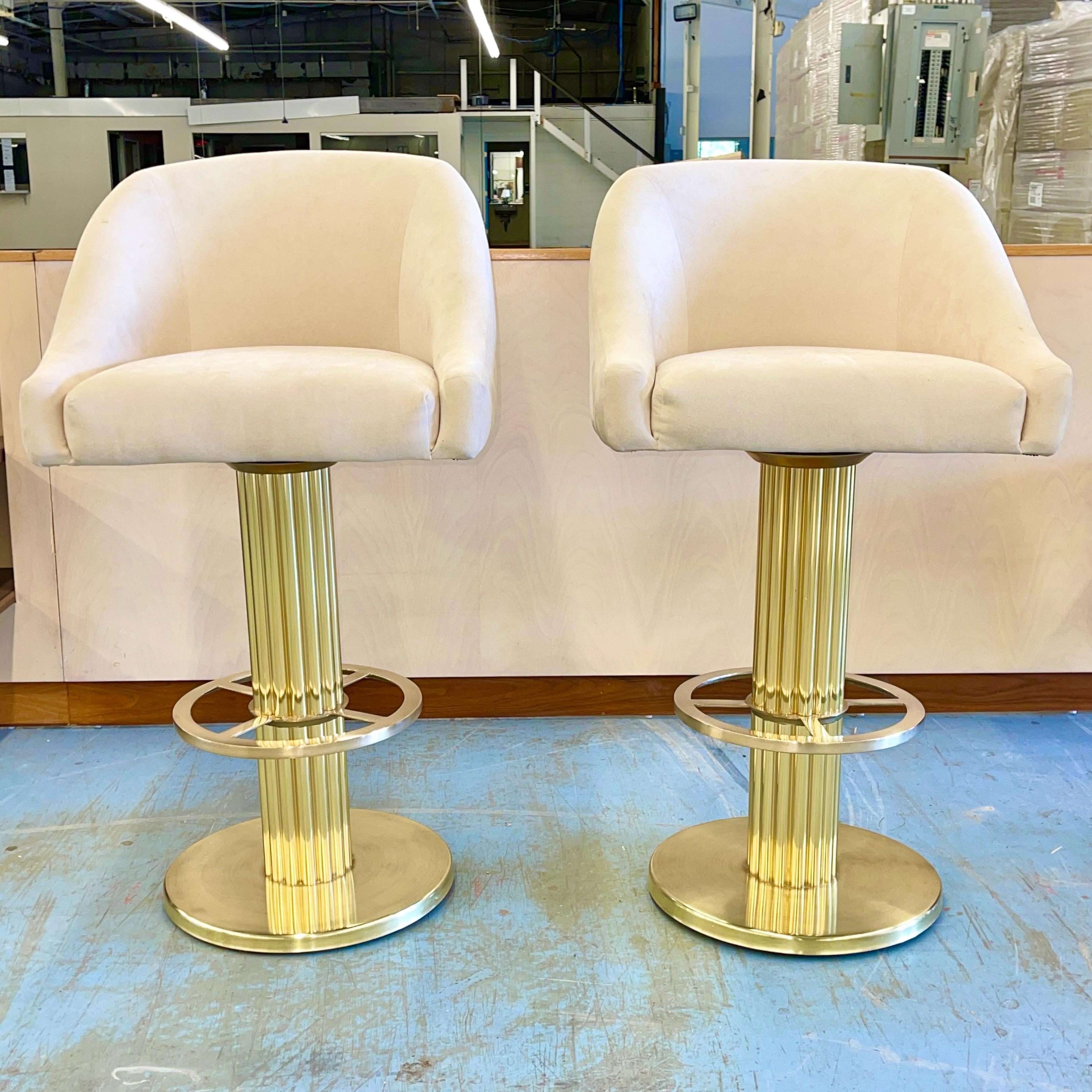 Pair of Excalibur barrel back swivel seat bar stools with solid polished brass bases designed by Howard Kaye of Design for Leisure Ltd. of Mt. Kisco, NY, circa 1988. Patented 1991. Produced 1998, last year of production.
Seats are in their original