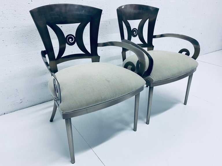 Pair of whimsical steel chairs with brushed finish and cushioned seat by Design Institute of America DIA, 1993. Seat is as is and will need new upholstery.